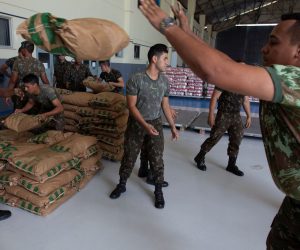 epa07388257 Brazilian soldiers organize a shipment with humanitarian aid destined for Venezuela in Boa Vista, Brazil, 22 February 2019. The first plane with the humanitarian aid that Brazil will send to Venezuela arrived on the same day to the bordering state of Roraima, from which it will try to to move it to the neighboring country a day later, in spite of the closing of the border ordered by the Government of Nicolas Maduro. The Brazilian Air Force plane landed at the military base in Boa Vista with a load of 22 tons of milk powder and about 500 first aid kits, which include medicines and other medical materials donated by the Government of Jair Bolsonaro.  EPA/JOEDSON ALVES