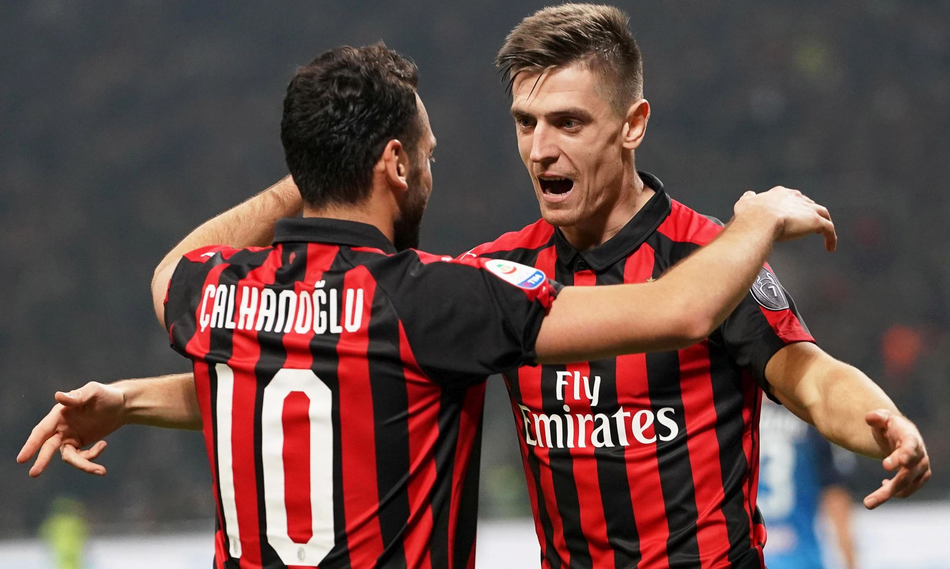 epa07389050 Milan's Krzysztof Piatek (R) celebrates with his teammate Hakan Calhanoglu (L) after scoring the 1-0 lead during the Italian Serie A soccer match between AC Milan and Empoli FC at the Giuseppe Meazza stadium in Milan, Italy, 22 Februray 2019.  EPA/DANIEL DAL ZENNARO