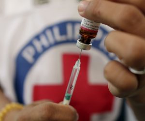 epa07373902 A Philippine Red Cross (PRC) health worker prepares a measles vaccine during a nationwide response program to immunization people at a slum area in Manila, Philippines, 16 February 2019. According to reports, an intensive vaccination program has been launched in Metro Manila and other affected areas to fight the measles outbreak. More than 70 people, mostly children under four-years of age, have been confirmed dead from the measles outbreak and over 4,300 people have fallen ill.  EPA/FRANCIS R. MALASIG