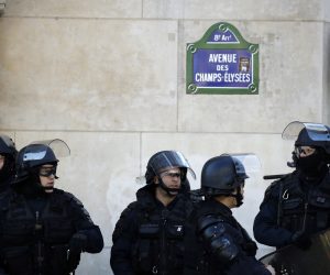 epa07389891 French anti-riot police stand at the Champs Elysees as protesters from the 'Gilets Jaunes' (Yellow Vests) movement  take part in the 'Act XV' demonstration (the 15th consecutive national protest on a Saturday) in Paris, France, 23 February 2019. The so-called 'gilets jaunes' (yellow vests) is a grassroots protest movement with supporters from a wide span of the political spectrum, that originally started with protest across the nation in late 2018 against high fuel prices. The movement in the meantime also protests the French government's tax reforms, the increasing costs of living and some even call for the resignation of French President Emmanuel Macron.  EPA/YOAN VALAT