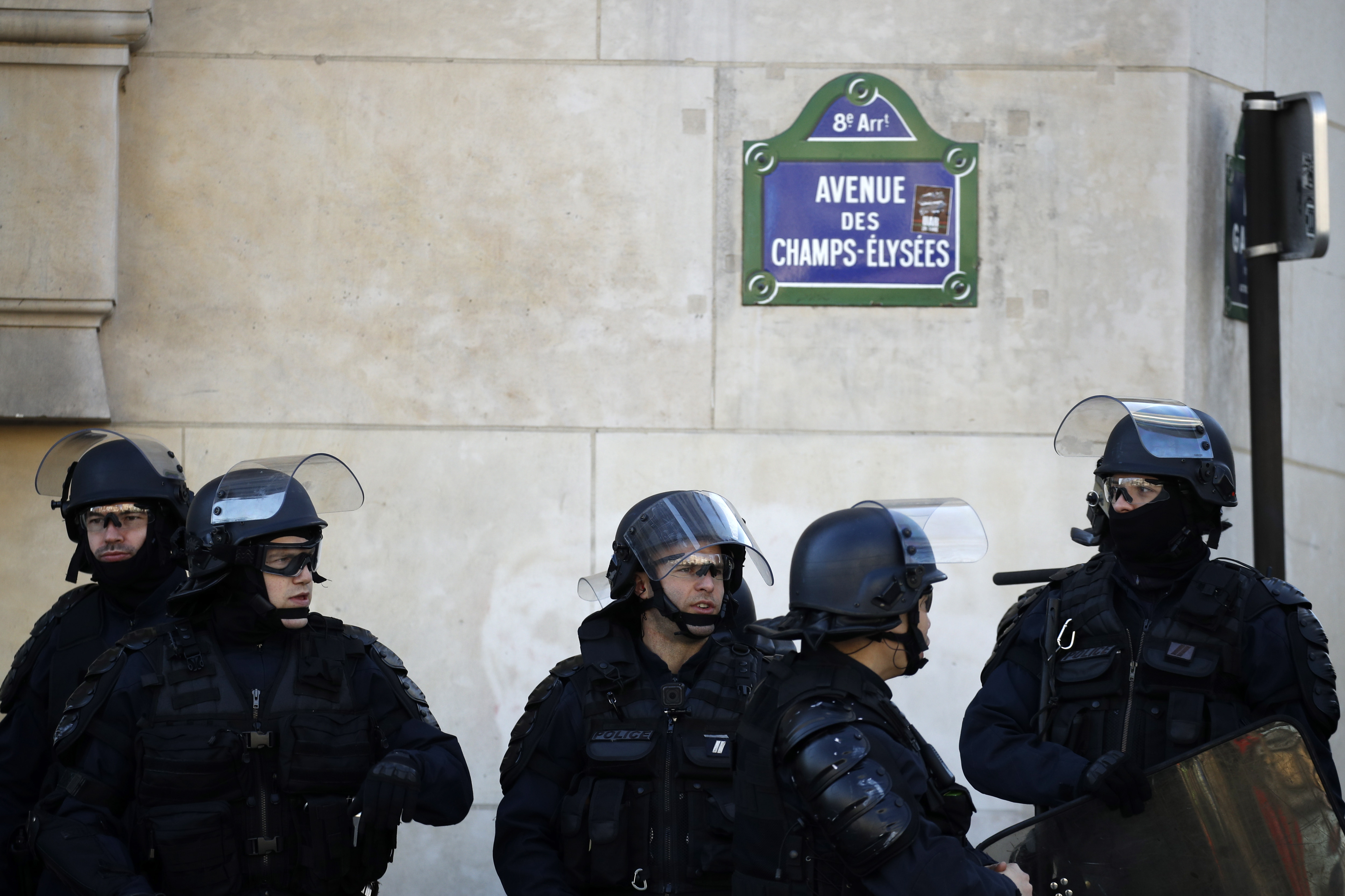 epa07389891 French anti-riot police stand at the Champs Elysees as protesters from the 'Gilets Jaunes' (Yellow Vests) movement  take part in the 'Act XV' demonstration (the 15th consecutive national protest on a Saturday) in Paris, France, 23 February 2019. The so-called 'gilets jaunes' (yellow vests) is a grassroots protest movement with supporters from a wide span of the political spectrum, that originally started with protest across the nation in late 2018 against high fuel prices. The movement in the meantime also protests the French government's tax reforms, the increasing costs of living and some even call for the resignation of French President Emmanuel Macron.  EPA/YOAN VALAT