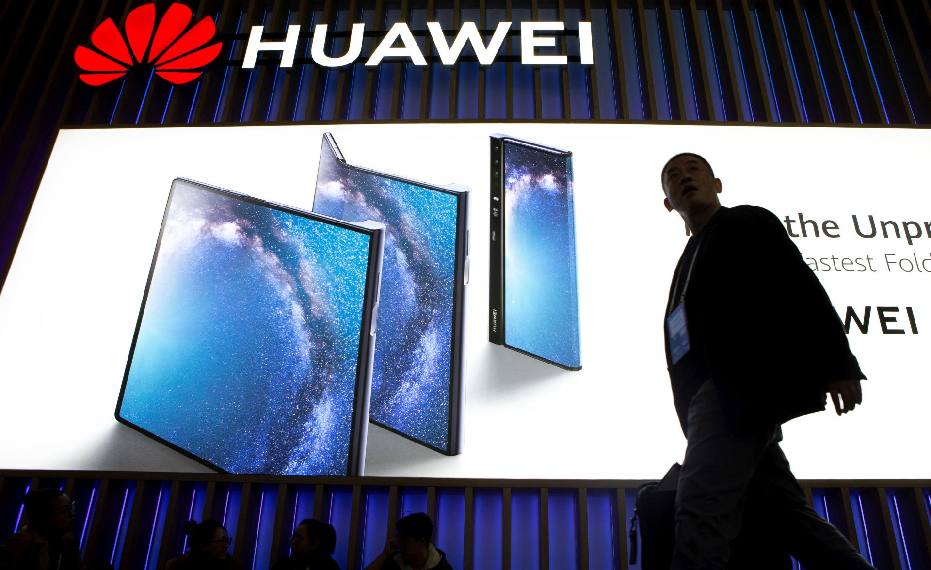 epa07396786 A visitor walks past the stand of Huawei on the opening day of the Mobile World Congress 2019 (MWC19), in Barcelona, Spain, 25 February 2019. The MWC19 will present the latest advances in mobile technologies from 25 to 28 February at the Fira Barcelona Montjuic.  EPA/Enric Fontcuberta