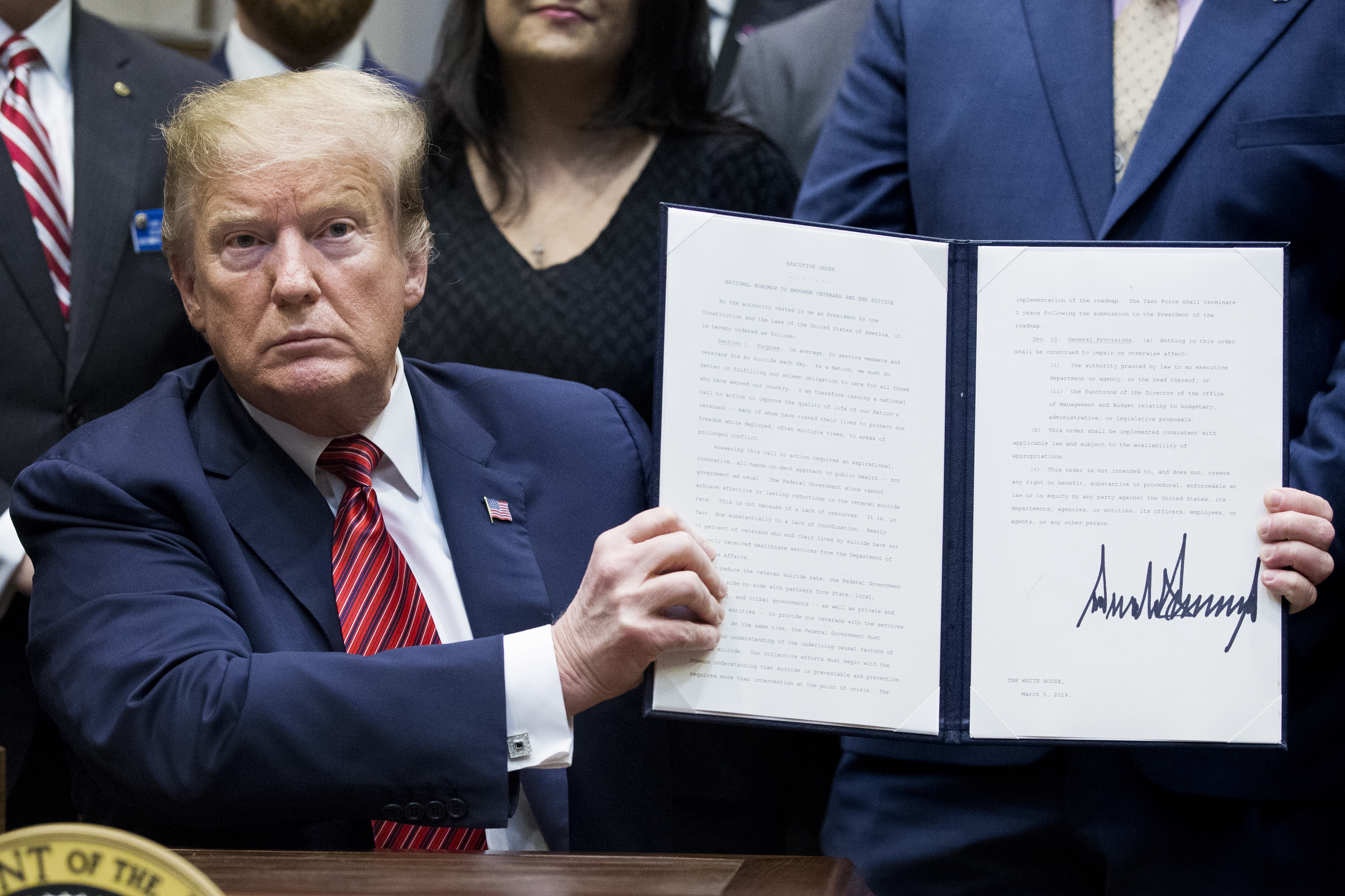 epa07415936 US President Donald J. Trump holds up an executive order he just signed - a 'President's Roadmap to Empower Veterans and End a National Tragedy of Suicide', also known as 'the PREVENTS initiative'; in the Roosevelt Room of the White House in Washington, DC, USA, 05 March 2019. A task force newly-created by the White House aims to coordinate research and veteran suicide prevention efforts across numerous government agencies. An estimated twenty US service members and veterans die by suicide each day.  EPA/MICHAEL REYNOLDS