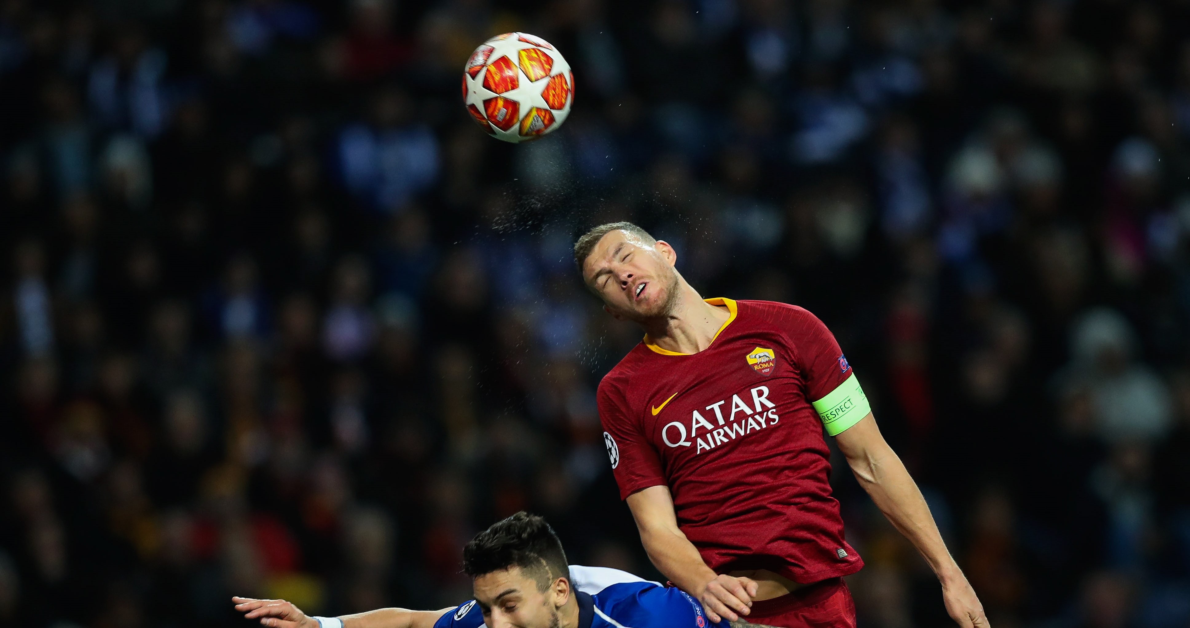 epa07418240 FC Porto's Alex Telles (L) in action against Roma Edin Dzeko during their Champions League lround of 16 second leg soccer match, held at Dragao stadium, Porto, Portugal, 6 March 2019.  EPA/JOSE COELHO