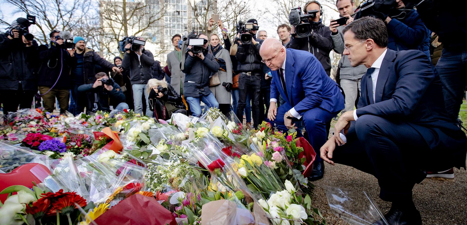 epa07448700 Dutch Prime Minister Mark Rutte (R) and Minister of Justice and Security Ferdinand Grapperhaus place floral tributes near the scene of the fatal shooting at 24 Oktoberplein, in Utrecht, The Netherlands, 19 March 2019. Three people were killed and five wounded, in a shooting on a tram in Utrecht, on 18 March 2019 The suspect involved in the attack, Gokmen Tanis, aged 37 born in Turkey, has been arrested by the police.  EPA/ROBIN VAN LONKHUIJSEN