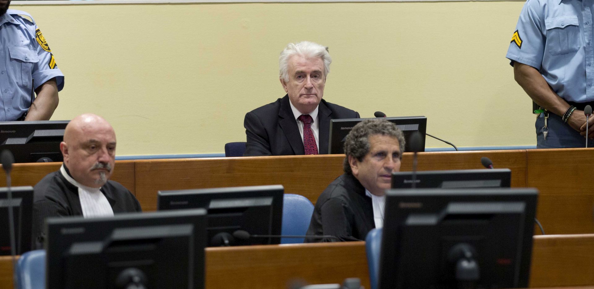 epa07450646 Former Bosnian Serb leader Radovan Karadzic (C, rear) sits in the court room of the International Residual Mechanism for Criminal Tribunals in The Hague, Netherlands, 20 March 2019. Nearly a quarter of a century since Bosnia's devastating war ended, Karadzic is set to hear the final judgment on whether he can be held criminally responsible for unleashing a wave of murder and destruction. United Nations appeals judges will on Wednesday rule whether to uphold or overturn Karadzic's 2016 convictions for genocide, crimes against humanity and war crimes, as well as his 40-year sentence.  EPA/PPETER DEJONG