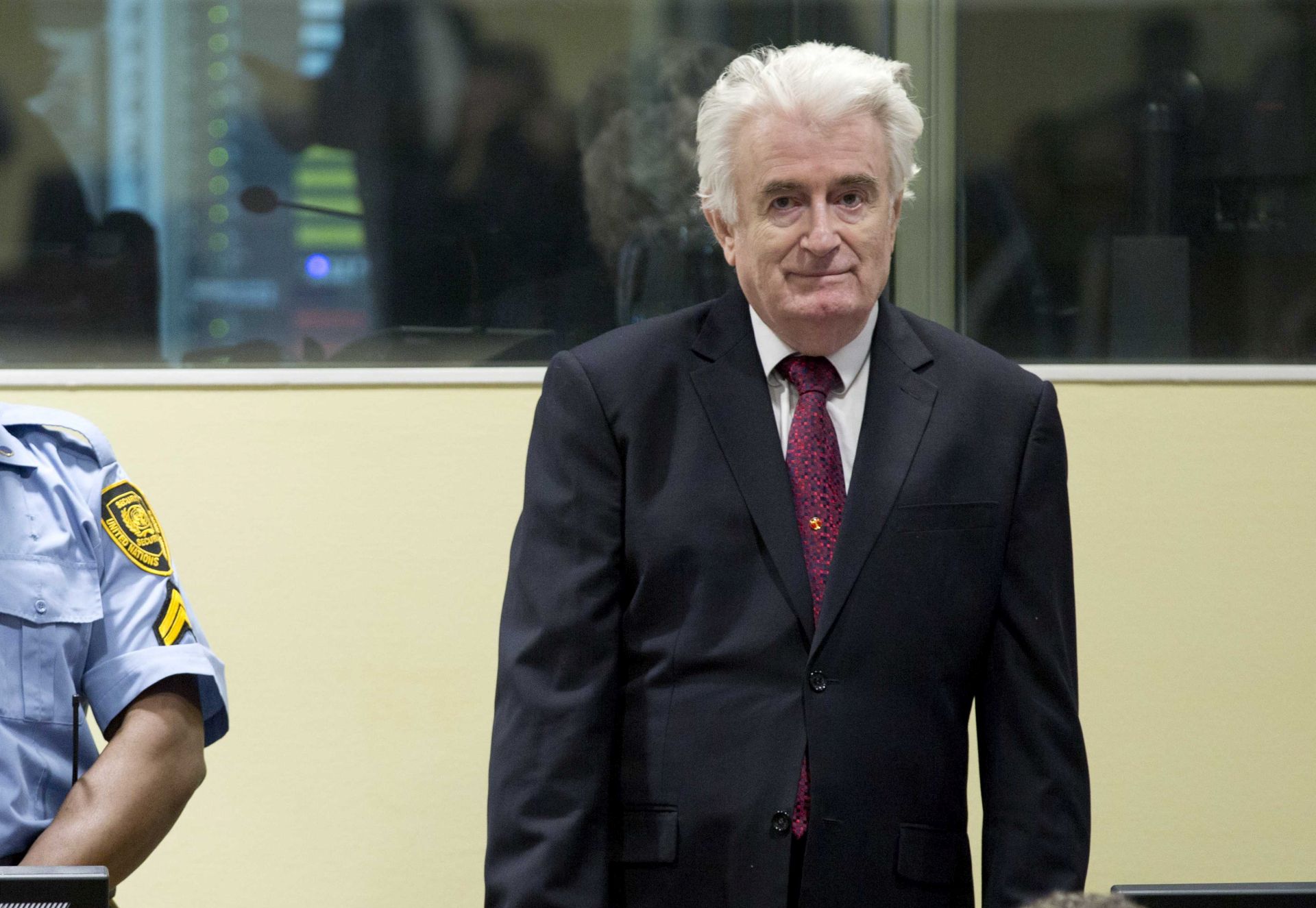 epa07450691 Former Bosnian Serb leader Radovan Karadzic (R) enters the court room of the Former Bosnian Serb leader Radovan Karadzic (R) enters the court room of the International Residual Mechanism for Criminal Tribunals in The Hague, Netherlands, 20 March 2019. Nearly a quarter of a century since Bosnia's devastating war ended, Karadzic is set to hear the final judgment on whether he can be held criminally responsible for unleashing a wave of murder and destruction. United Nations appeals judges will on Wednesday rule whether to uphold or overturn Karadzic's 2016 convictions for genocide, crimes against humanity and war crimes, as well as his 40-year sentence.  EPA/PETER DEJONG / POOL