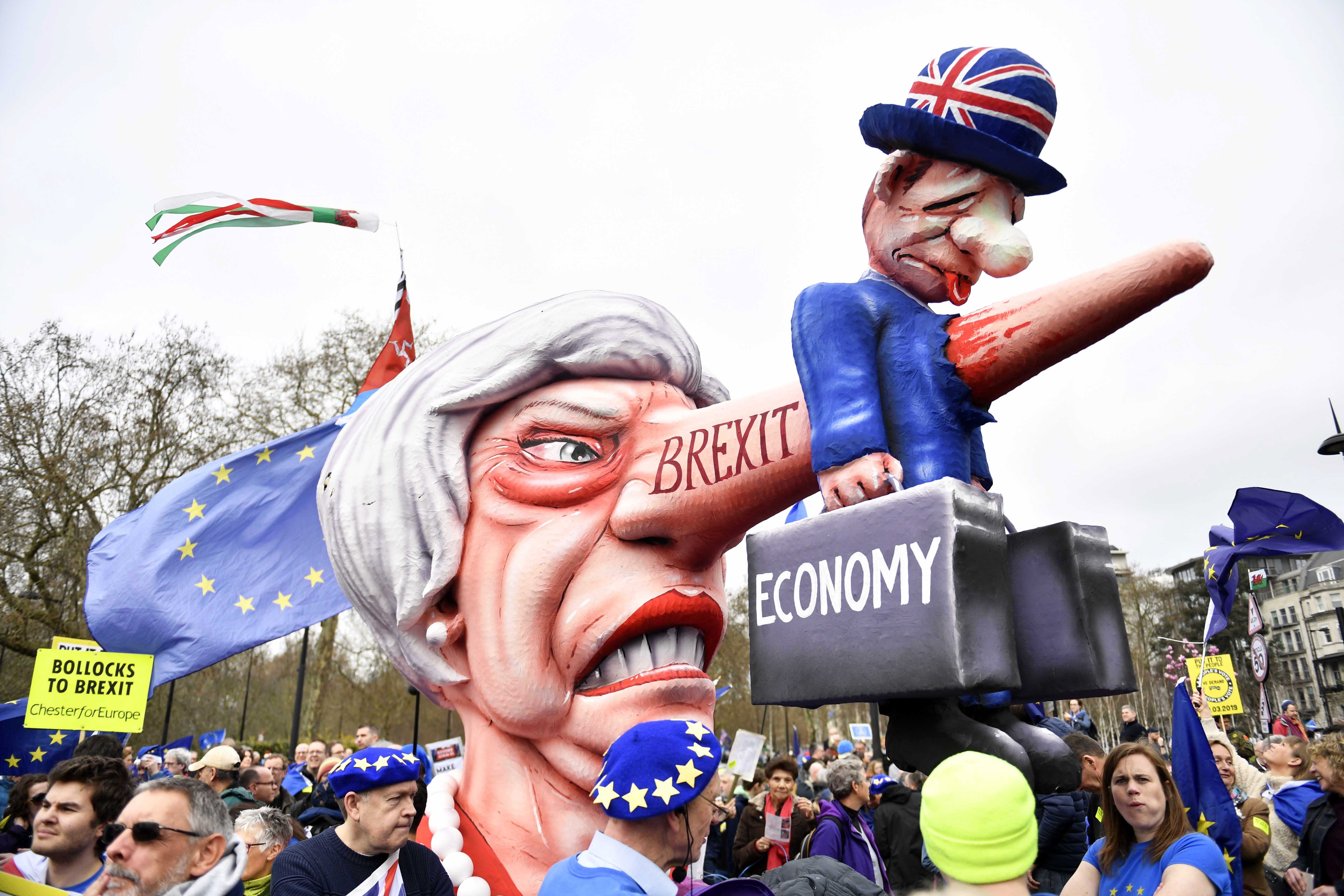 epaselect epa07458307 A float depicting British Prime Minister Theresa May is seen during the 'Put it to the People' march in TLondon, Britain, 23 March 2019. Hundreds of thousands of people take part in the protest calling for a referendum on the final Brexit deal.  EPA/NEIL HALL