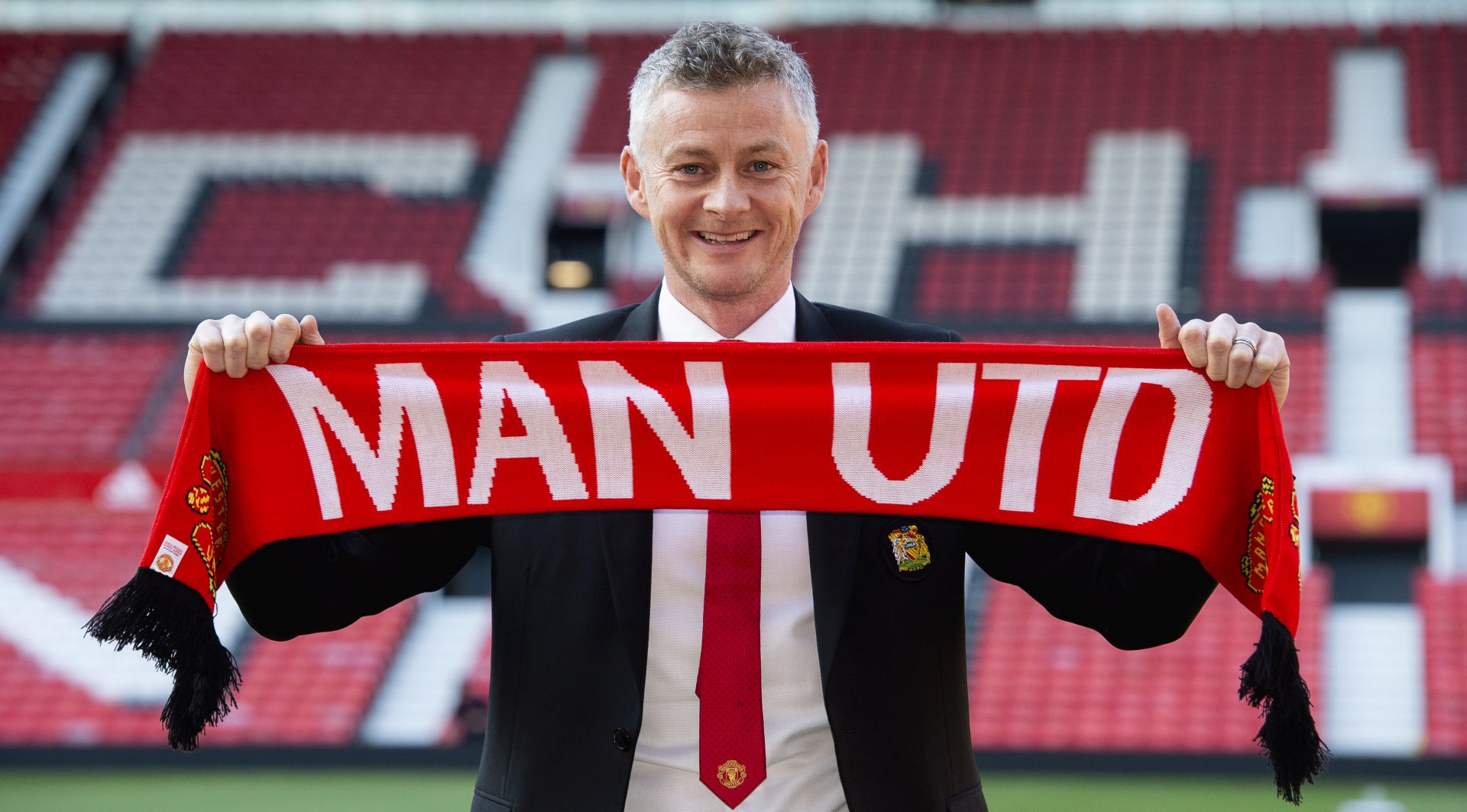 epa07469147 Ole Gunnar Solskjaer holds a scarf pitch side inside Old Trafford after being announced as the new manager of Manchester United  at Old Trafford, Manchester, Britain, 28 March 2019.  EPA/PETER POWELL EDITORIAL USE ONLY. No use with unauthorized audio, video, data, fixture lists, club/league logos or 'live' services. Online in-match use limited to 120 images, no video emulation. No use in betting, games or single club/league/player publications