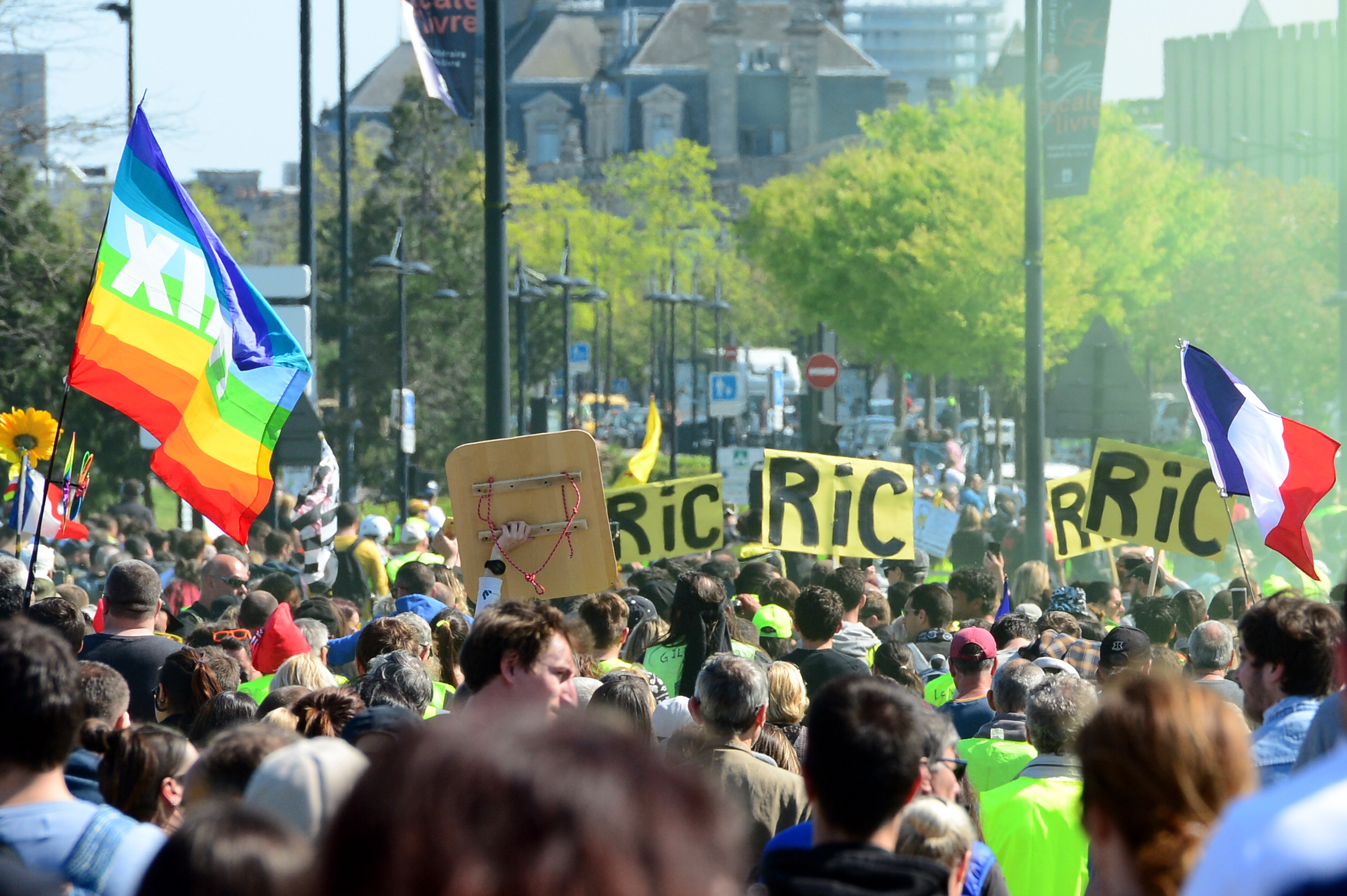 epa07473047 Protesters from the 'Gilets Jaunes' (Yellow Vests) movement hold 
banner reading 'RIC' (Citizens' Initiative Referendum)' during the 'Act XX' demonstration (the 20th consecutive national protest on a Saturday) in Bordeaux, France, 30 March 2019. Yellow Vest protests are expected in several cities across France.  EPA/CAROLINE BLUMBERG