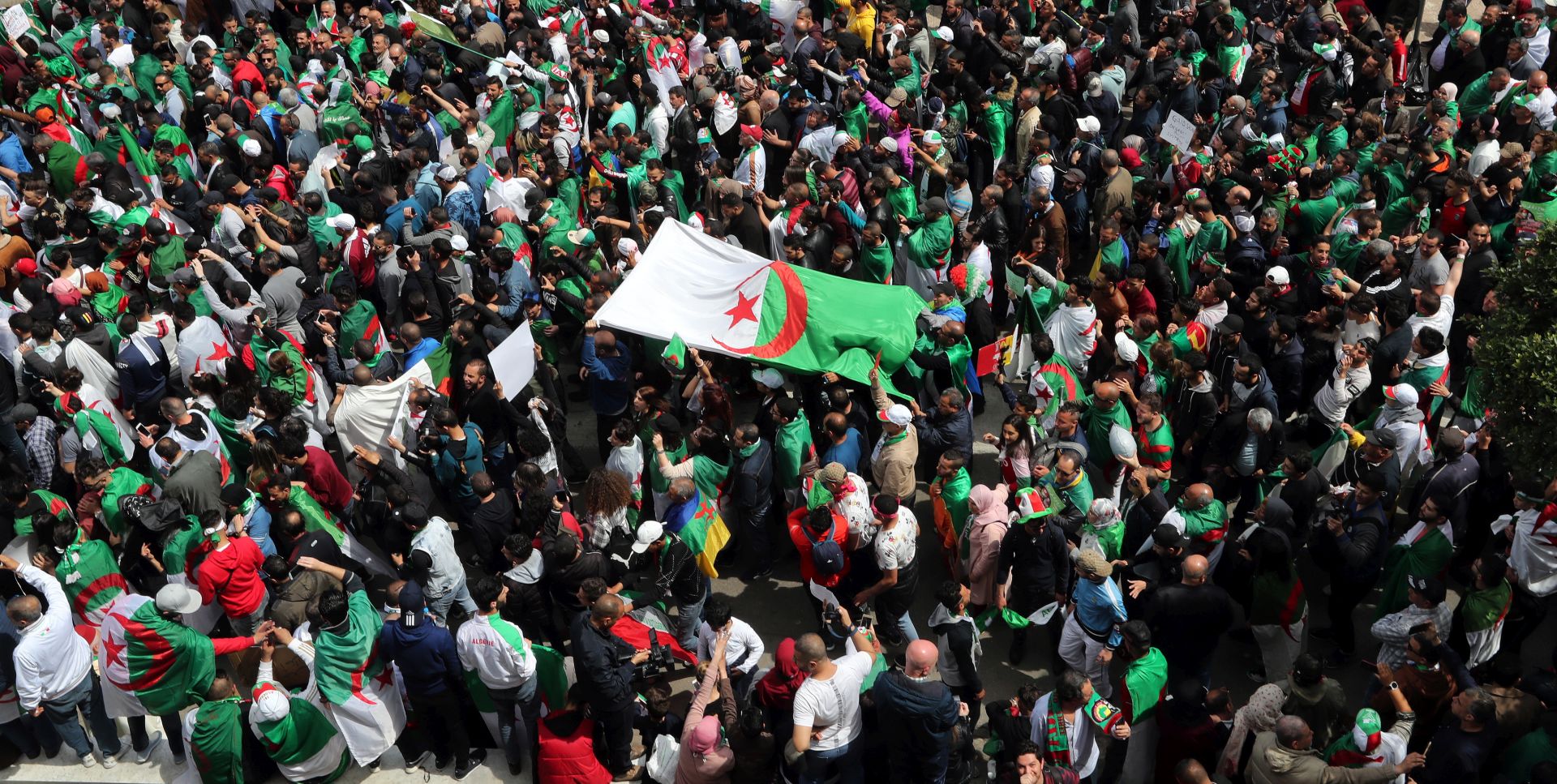 epa07501548 Algerians shout slogans during a protest against interim President Abdelkader Bensalah, in Algiers, Algeria, 12 April 2019. Media reports state that Abdelkader Bensalah has said that Algeria will hold presidential elections on 04 July 2019.  EPA/MOHAMED MESSARA