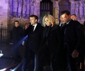 epa07509136 French President Emmanuel Macron (C) and his wife Brigitte Macron (R) pay a visit to firemen fighting against a fire burning the roof of the Notre-Dame cathedral in Paris, France, 15 April 2019. A fire started in the late afternoon in one of the most visited monuments of the French capital.  EPA/YOAN VALAT