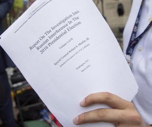 epa07514220 A reporter holds a printout of the redacted version of Special Counsel Robert Mueller's report on Russian interference in the 2016 election minutes after its release outside the US Department of Justice in Washington, DC, USA, 18 April 2019. According to news reports, Mueller and his team could not conclude that US President Donald J. Trump obstructed justice during the investigation.  EPA/ERIK S. LESSER