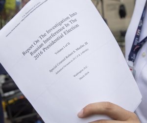 epa07514220 A reporter holds a printout of the redacted version of Special Counsel Robert Mueller's report on Russian interference in the 2016 election minutes after its release outside the US Department of Justice in Washington, DC, USA, 18 April 2019. According to news reports, Mueller and his team could not conclude that US President Donald J. Trump obstructed justice during the investigation.  EPA/ERIK S. LESSER