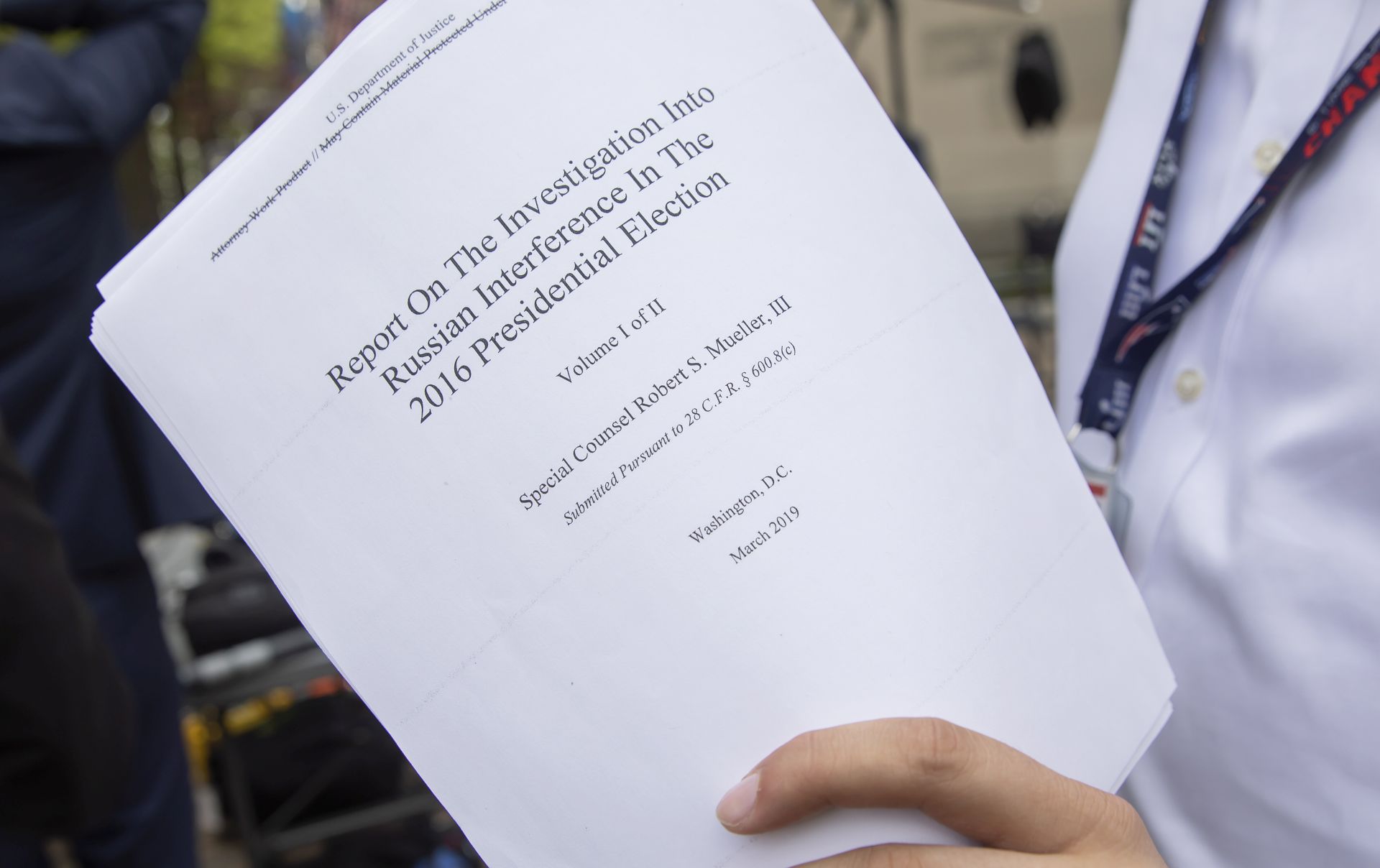 epa07514220 A reporter holds a printout of the redacted version of Special Counsel Robert Mueller's report on Russian interference in the 2016 election minutes after its release outside the US Department of Justice in Washington, DC, USA, 18 April 2019. According to news reports, Mueller and his team could not conclude that US President Donald J. Trump obstructed justice during the investigation.  EPA/ERIK S. LESSER
