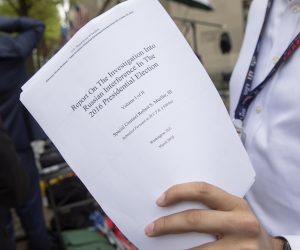 epa07514220 A reporter holds a printout of the redacted version of Special Counsel Robert Mueller's report on Russian interference in the 2016 election minutes after its release outside the US Department of Justice in Washington, DC, USA, 18 April 2019. According to news reports, Mueller and his team could not conclude that US President Donald J. Trump obstructed justice during the investigation.  EPA/ERIK S. LESSER