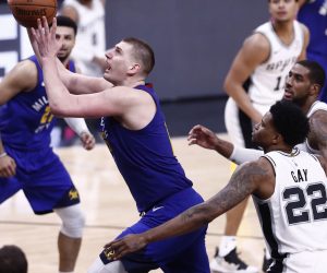 epa07518493 Denver Nuggets player Nikola Jokic of Serbia (L) goes to the basket against San Antonio Spurs players Rudy Gay (C) and LaMarcus Aldridge (R) during the NBA Western Conference Playoffs game four at the AT&T Center in San Antonio, Texas, USA, 20 April 2019.  EPA/LARRY W. SMITH SHUTTERSTOCK OUT SHUTTERSTOCK OUT
