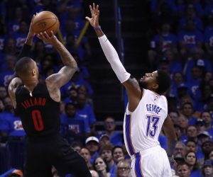 epa07520849 Portland Trail Blazers player Damian Lilliard (L) takes a shot against Oklahoma City Thunder player Paul George (R) during the NBA Western Conference Playoffs basketball game four between the Portland Trail Blazers and Oklahoma City Thunder at the Chesapeake Energy Arena in Oklahoma City, Oklahoma, USA, 21 April 2019.  EPA/LARRY W. SMITH SHUTTERSTOCK OUT