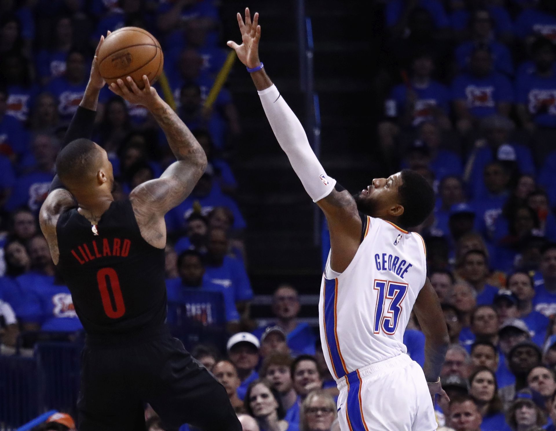 epa07520849 Portland Trail Blazers player Damian Lilliard (L) takes a shot against Oklahoma City Thunder player Paul George (R) during the NBA Western Conference Playoffs basketball game four between the Portland Trail Blazers and Oklahoma City Thunder at the Chesapeake Energy Arena in Oklahoma City, Oklahoma, USA, 21 April 2019.  EPA/LARRY W. SMITH SHUTTERSTOCK OUT