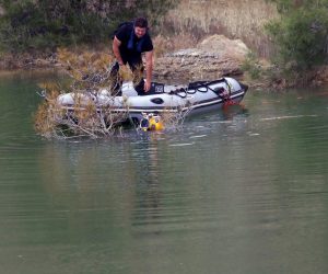 epa07530514 Firefighters and Investigators search the manmade lake near the village of Xiliato for the remains of more victims outside the Nicosia, Cyprus, 26 April 2019. Cyprus police is intensifying a search for the remains of more victims at locations where an army officer, who authorities say killed five women and two girls, had dumped their bodies.  EPA/KATIA CHRISTODOULOU