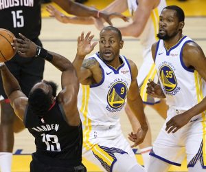 epa07535330 Houston Rockets guard James Harden (L) shoots while drawing a foul by Golden State Warriors guard Andre Iguodala (C) as Golden State Warriors forward Kevin Durant (R) looks on during the first half of the NBA Western Conference playoffs semifinals at Oracle Arena in Oakland, California, USA, 28 April 2019.  EPA/JOHN G. MABANGLO SHUTTERSTOCK OUT