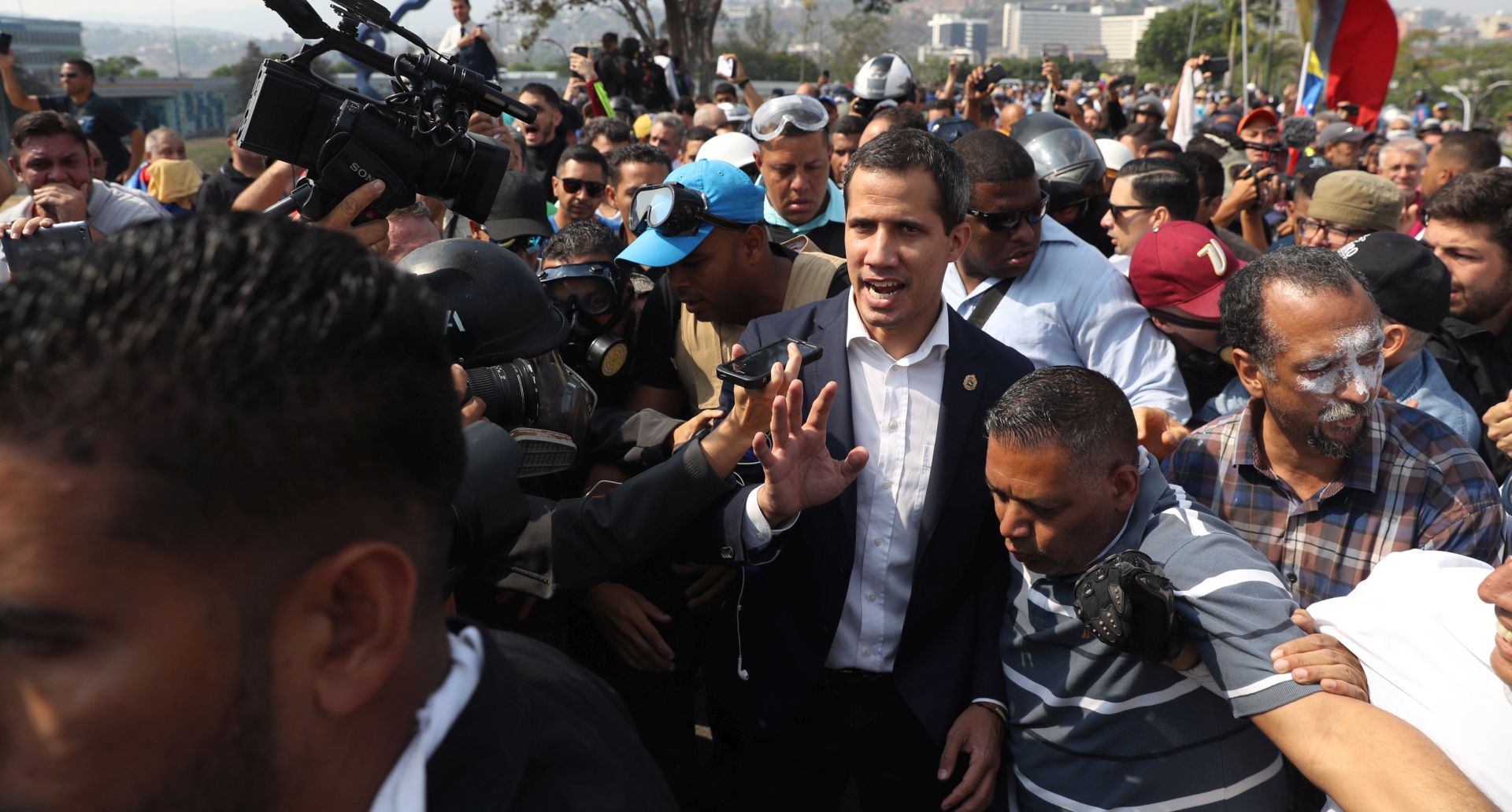 epa07538290 President of the Venezuelan Parliament Juan Guaido (c) participate in a demonstration in Caracas, Venezuela, 30 April 2019. Reports state that at least one person was injured during the clashes at La Carlota after Guaido called for mass anti-government protests backed by the military. Venezuelan interim President Juan Guaido has asked supporters to take to the streets in order to end the regime of President Nicolas Maduro. Meanwhile, Venezuelan opposition leader Leopoldo Lopez was freed from his house arrest, appearing alongside Guaido and military forces in Caracas.  EPA/Miguel Gutierrez