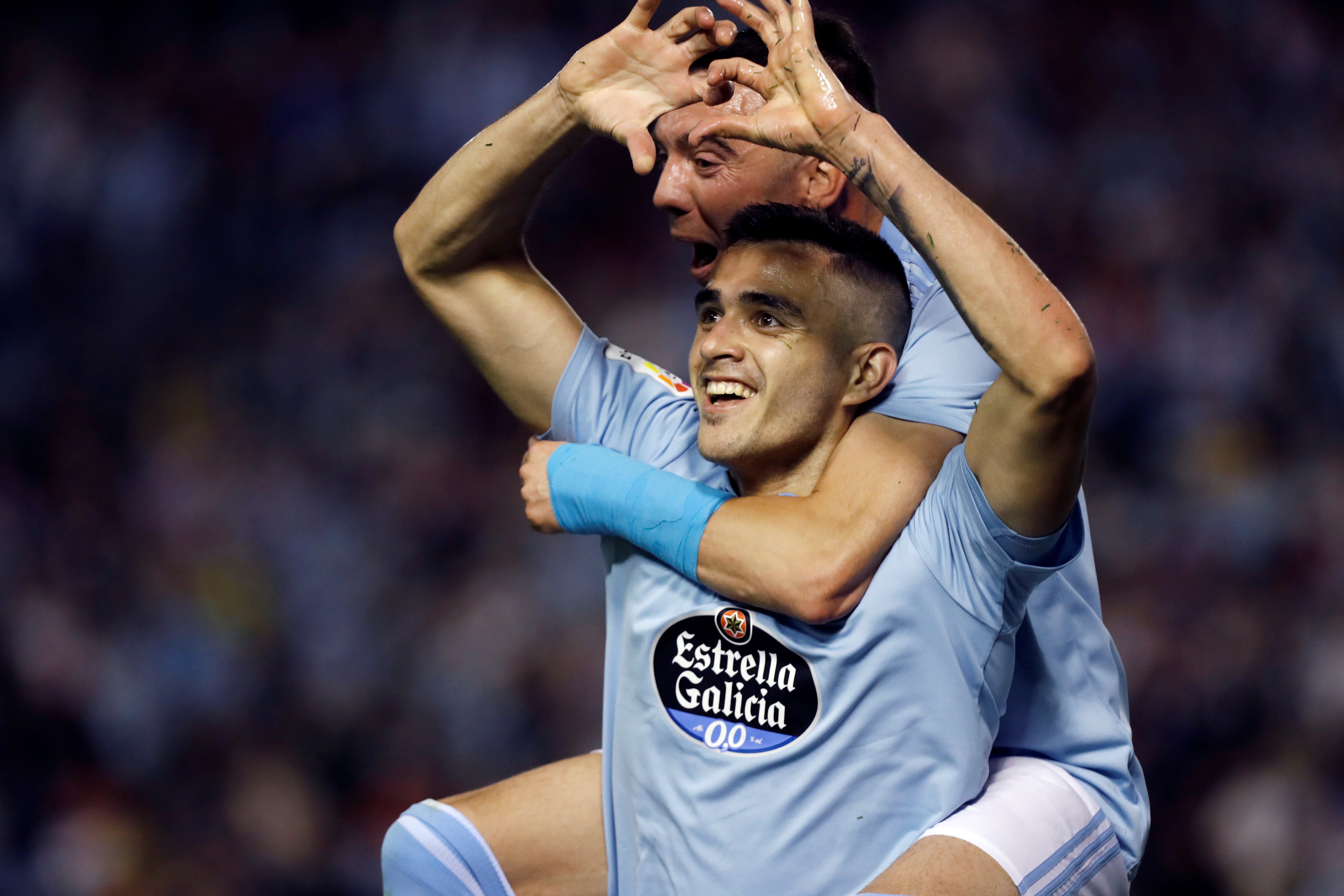 epa07547557 Celta de Vigo's Maxi Gomez (bottom) celebrates after scoring during a Spanish LaLiga soccer match between Celta de Vigo and FC Barcelona in Vigo, Galicia, northern Spain, 04 May 2019.  EPA/ELISEO TRIGO