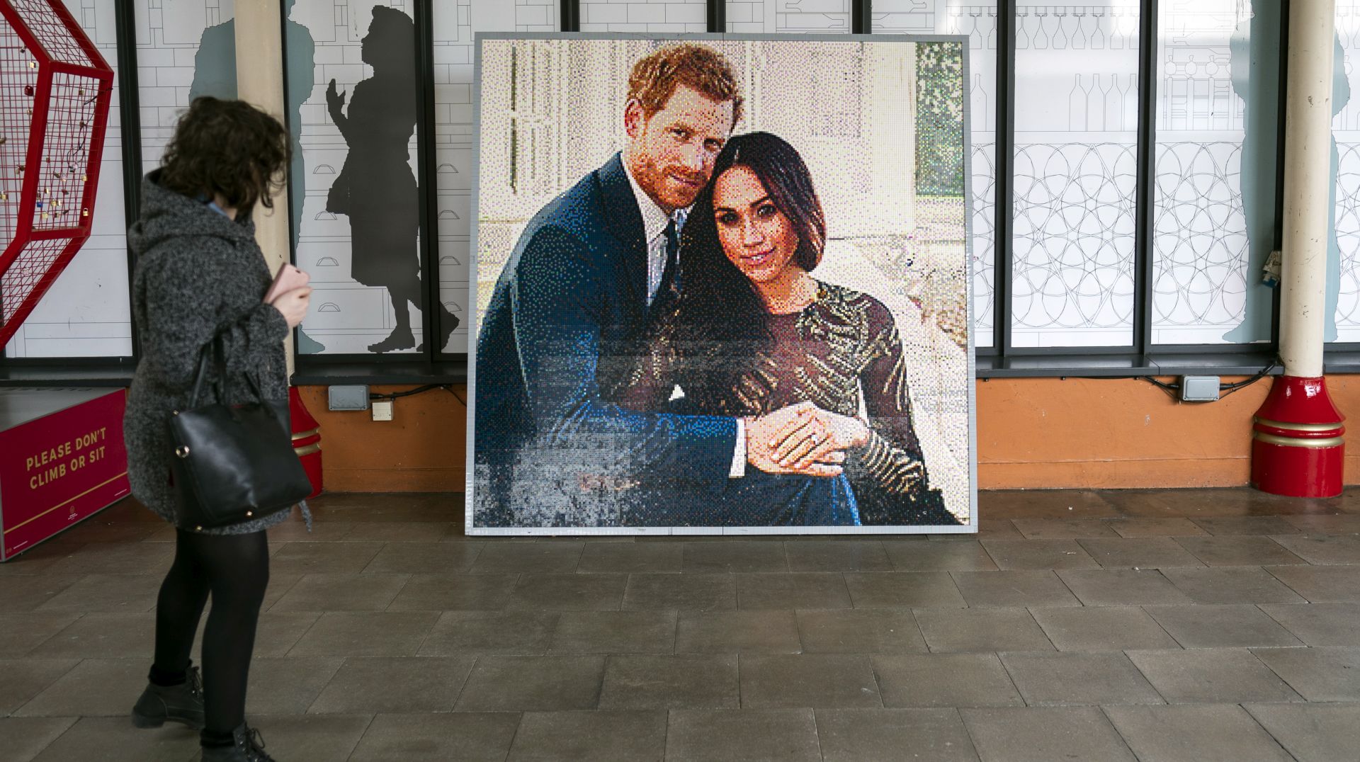 epa07550847 A member of the public passes a mural of the Duke and Duchess of Sussex outside Windsor Castle, in Windsor, Britain, 06 May 2019. Britain's Prince Harry Duke of Sussex and Meghan Duchess of Sussex are expecting their first baby any day.  EPA/WILL OLIVER