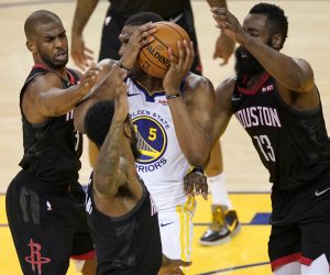 epa07556945 Golden State Warriors center Kevon Looney (C) looks to pass while getting pressured by Houston Rockets guard Chris Paul (L), Houston Rockets guard Iman Shumpert (C, bottom) and Houston Rockets guard James Harden (R) during the NBA Western Conference playoffs semifinal game five at Oracle Arena in Oakland, California, USA, 08 May 2019.  EPA/JOHN G. MABANGLO SHUTTERSTOCK OUT