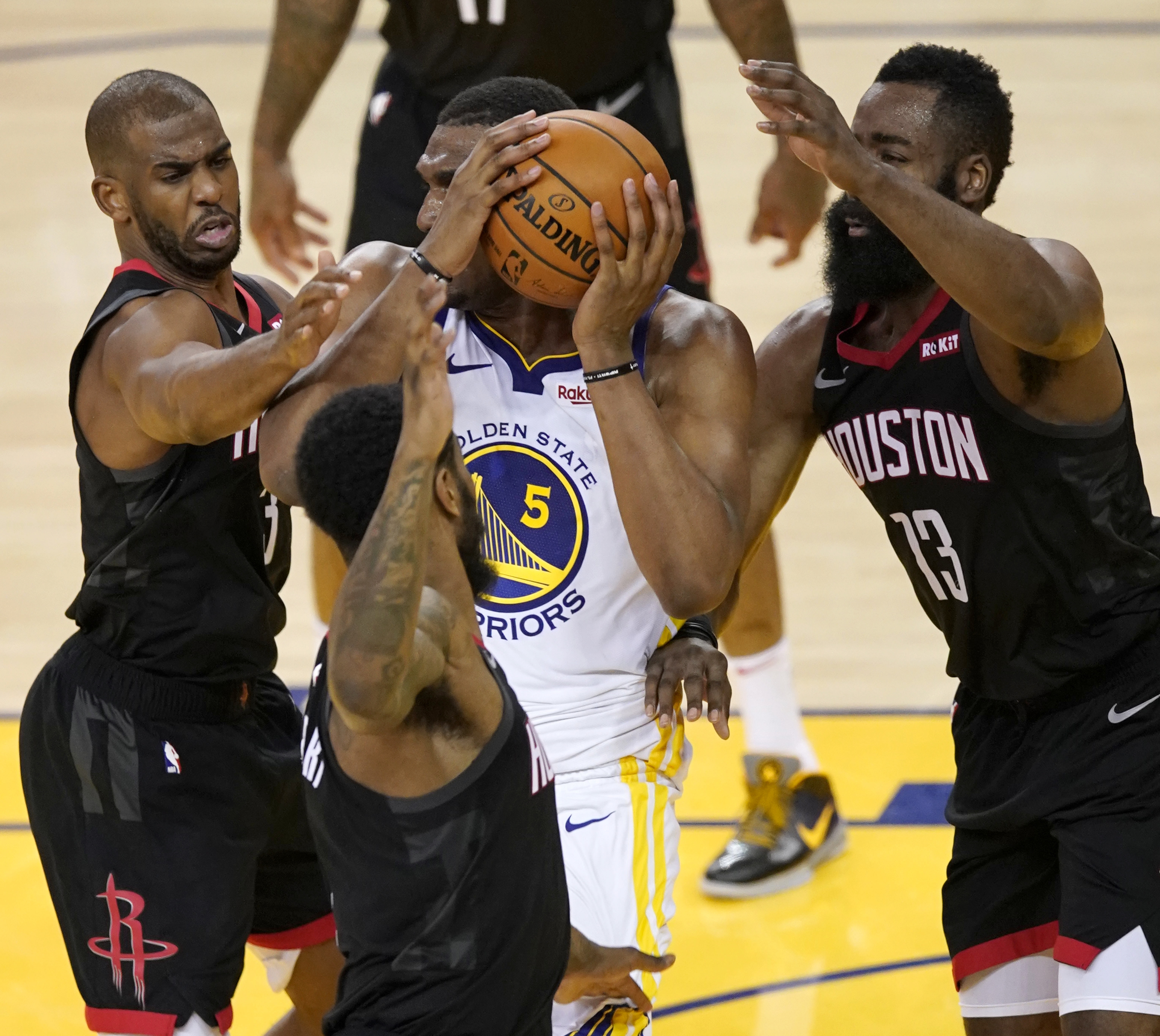 epa07556945 Golden State Warriors center Kevon Looney (C) looks to pass while getting pressured by Houston Rockets guard Chris Paul (L), Houston Rockets guard Iman Shumpert (C, bottom) and Houston Rockets guard James Harden (R) during the NBA Western Conference playoffs semifinal game five at Oracle Arena in Oakland, California, USA, 08 May 2019.  EPA/JOHN G. MABANGLO SHUTTERSTOCK OUT