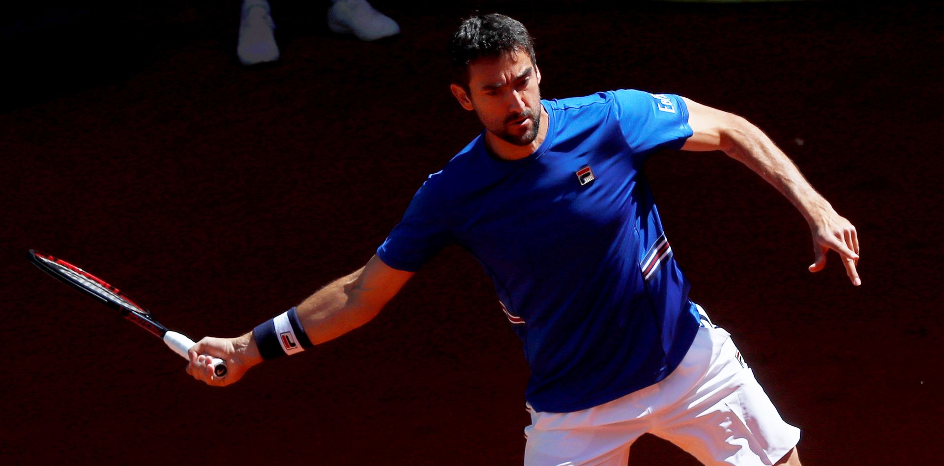 epa07557707 Marin Cilic of Croatia in action against Laslo Djere of Serbia during their third round match of the Mutua Madrid Open tennis tournament at the Caja Magica complex in Madrid, Spain, 09 May 2019.  EPA/CHEMA MOYA