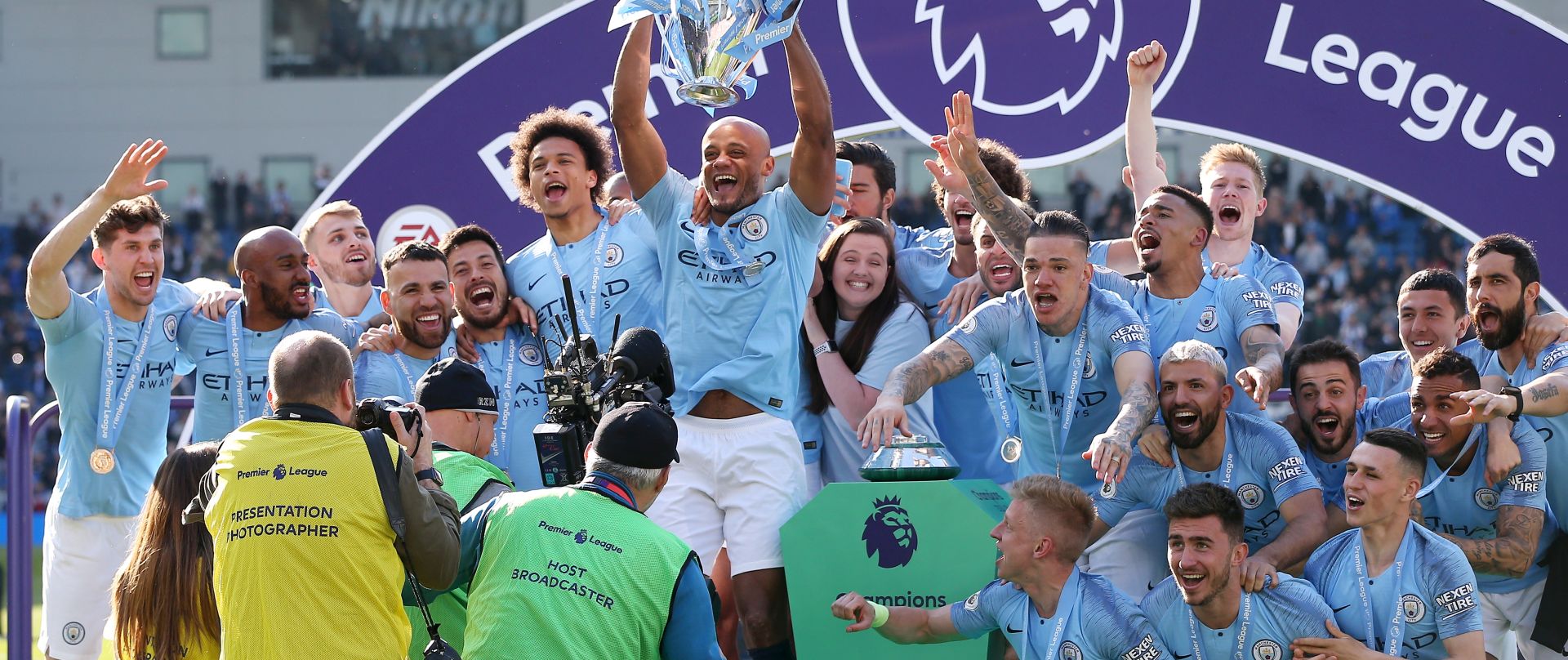 epa07565177 Manchester City captain Vincent Kompany lifts the trophy as the team celebrate after the English Premier League match between Brighton and Hove Albion and Manchester City, Brighton, Britain, 12 May 2019. Manchester City won 4-1 and won the Premier League title.  EPA/JAMES BOARDMAN EDITORIAL USE ONLY.  No use with unauthorized audio, video, data, fixture lists, club/league logos or 'live' services. Online in-match use limited to 120 images, no video emulation. No use in betting, games or single club/league/player publications.