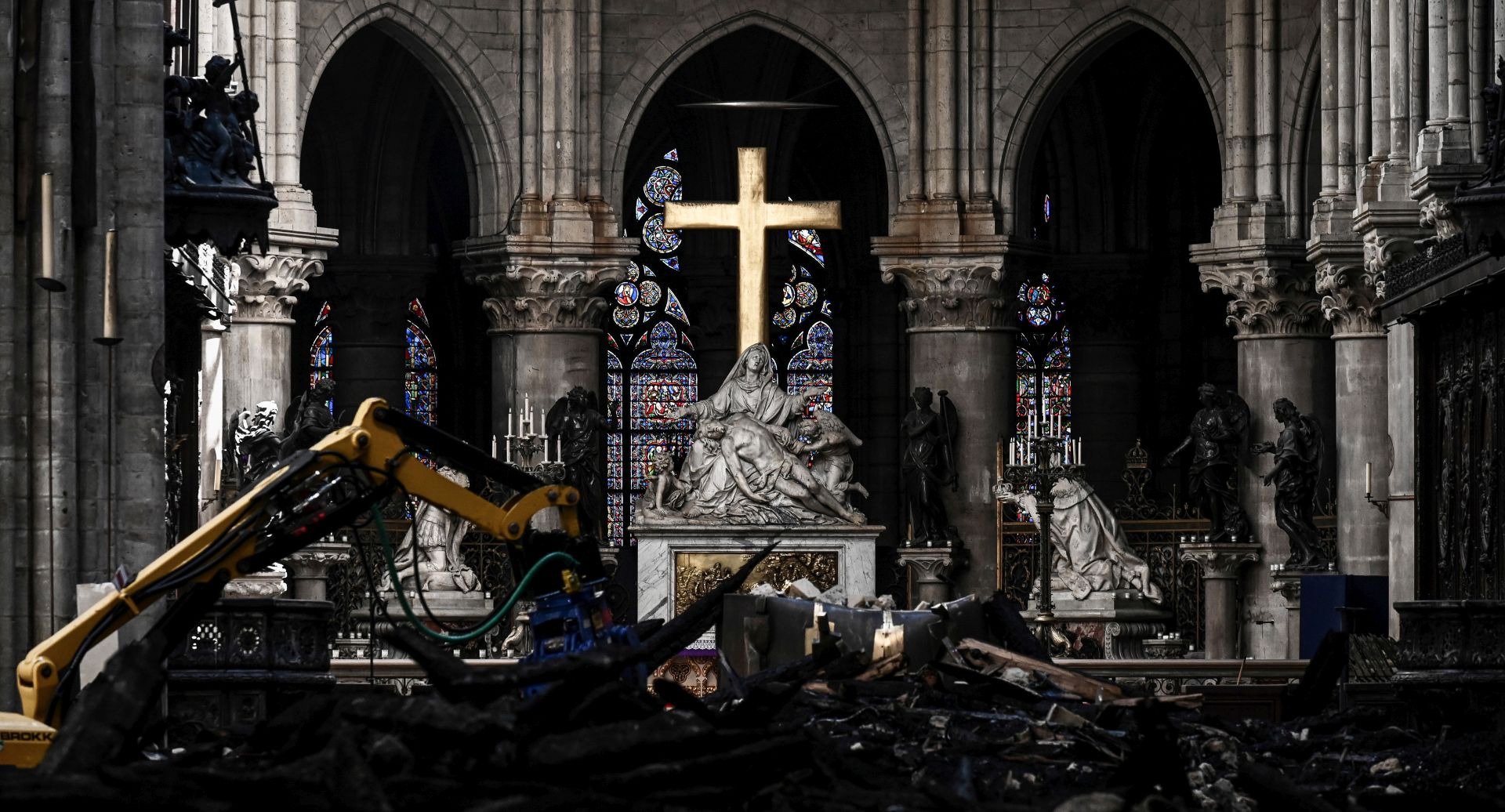 epa07572825 A picture shows rubble and the cross at the altar inside the the Notre Dame de Paris Cathedral after it sustained major fire damage the previous month, during a visit by the Canadian prime minister in Paris France, 15 May 2019. On 15 April, fire destroyed the roof and steeple of the 850-year-old Gothic cathedral. Images of the ancient cathedral going up in flames sparked shock and dismay across the globe as well as in France, where it is considered one of the nation's most beloved landmarks.  EPA/PHILIPPE LOPEZ  MAXPPP OUT