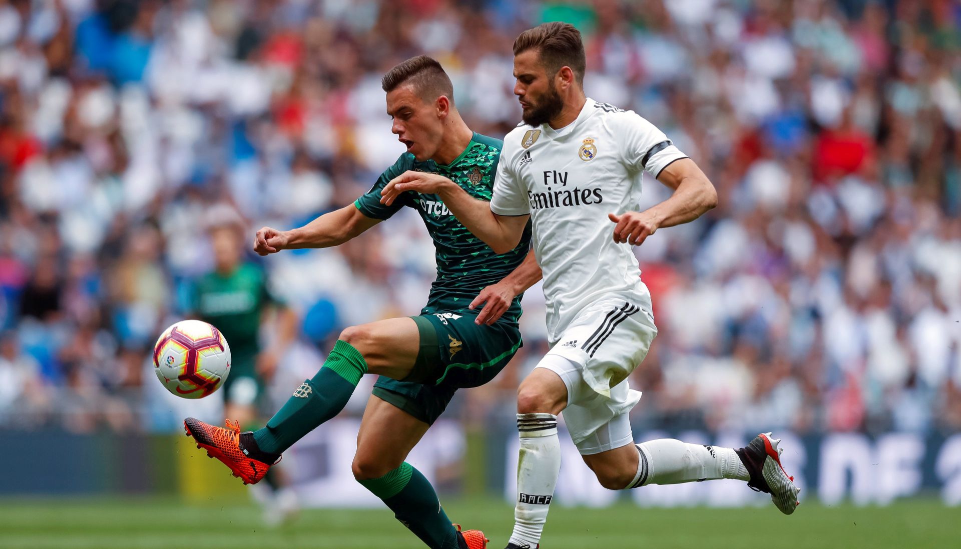 epa07583821 Real Madrid's defender Nacho Fernandez (R) in action against Real Betis' midfielder Giovani Lo Celso during their Spanish LaLiga soccer match at Santiago Bernabeu stadium in Madrid, Spain, 19 May 2019.  EPA/Emilio Naranjo