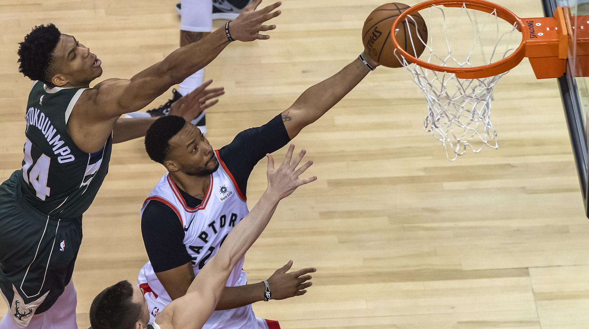 epa07585770 Toronto Raptors forward Norman Powell (R) goes to the basket between Milwaukee Bucks forward Giannis Antetokounmpo (L) of Greece and guard Pat Connaughton (L, bottom) in the first quarter of the NBA Eastern Conference Finals Game 3 basketball game between the Toronto Raptors and Milwaukee Bucks at Scotiabank Arena in Toronto, Canada, 19 May 2019.  EPA/WARREN TODA  SHUTTERSTOCK OUT