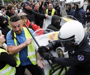 epa07602502 Protesters wearing yellow vests, commonly worn by transport drivers', clash with police during a protest against higher fuel prices organized by French and Belgium members of the yellow vests movement near European institution headquarters in Brussels, Belgium, 26 May 2019. The protest was aimed at disrupting the European Union institutes during the organizations elections, but protester broken up and arrested before the demonstration started.  EPA/OLIVIER HOSLET