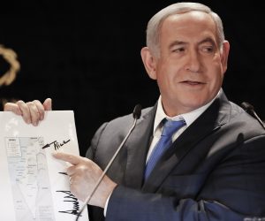 epa07613282 Israeli Prime Minister Benjamin Netanyahu points to the Golan Heights on a map of Israel featuring the signature of US President Donald J. Trump, while delivering a statement to members of the news media in Jerusalem, Israel, 30 May 2019. A visit by Senior Advisor to the White House Jared Kushner, comes one day after the Israeli parliament dissolved itself after Netanyahu failed to form a government coalition. The visit is also shortly ahead of Israeli-Palestinian peace plan talks scheduled in Manama.  EPA/ATEF SAFADI