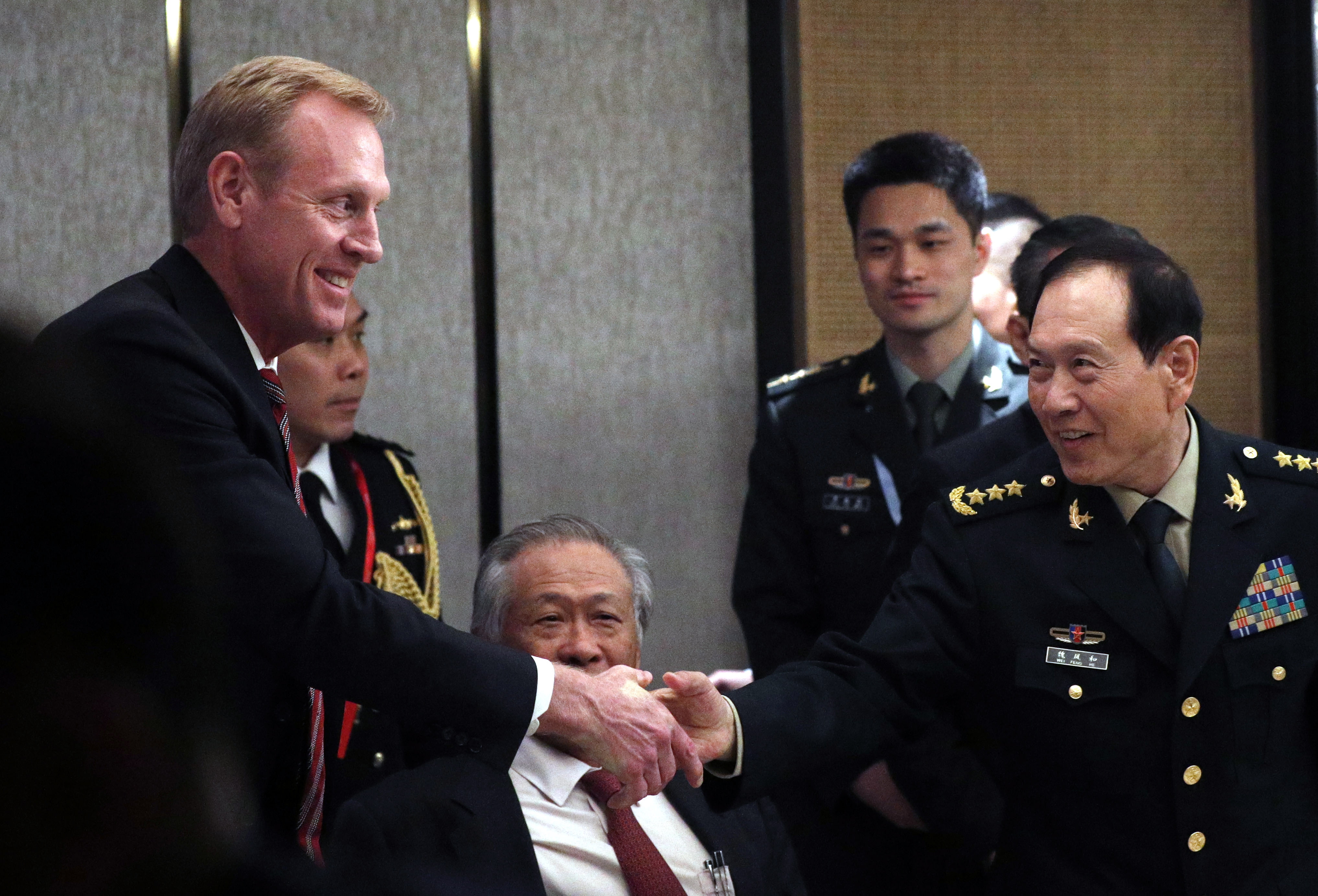 epa07616897 Acting US Secretary of Defense Patrick Shanahan (L) and Chinese Minister of Defense General Wei Fenghe (R) shakes hands during a ministerial roundtable on the sidelines of the International Institute for Strategic Studies (IISS) 18th Asia Security Summit in Singapore, 01 June 2019. The IISS Asia Security Summit is an annual gathering of defense officials in the Asia-Pacific region and is dubbed the Shangri-La Dialogue in honor of the hotel where the event is held. The summit will be held from 31 May to 02 June 2019.  EPA/WALLACE WOON