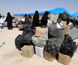 epa07623496 Wives of Islamic state fighters (IS) wait next to their belongings upon their deportation from the al-Hol camp for refugees in al-Hasakah governorate in northeastern Syria on 03 June 2019 (issued 04 June 2019).  According to media reports, the Kurdish authorities in northeast Syria are handing over 800 women and children all of them Syrian, including relatives of Islamic state fighters, to their families in the first such transfer from an overcrowded camp.  EPA/AHMED MARDNLI