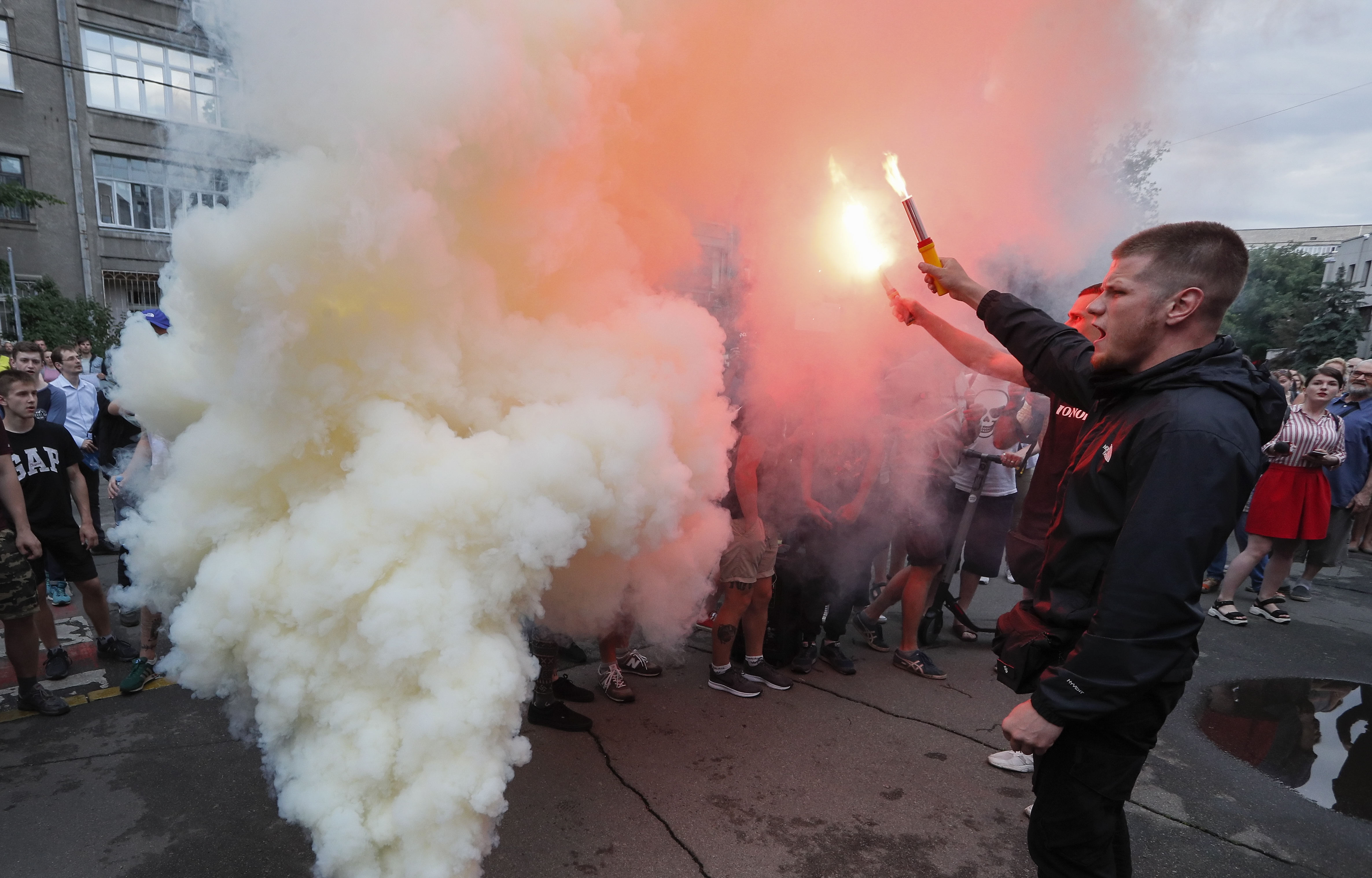 epa07625842 Activists burn flares and smoke grenades during their rally in front of Interior Ministry office in Kiev, Ukraine, 04 June 2019. Ukrainians gathered demanding for the resignation of the Interior Minister Arsen Avakov after Kiril Tlyavov, a 5-year-old boy was killed as a result of two police officers shooting. Ivan Prykhodko and Volodymyr Petrovets, two police officers who are suspected of the murder of the boy in Kyiv region, have been arrested for 60 days without the possibility of bail. At present, the main version is that the police officers, who under the influence of alcohol had staged a firearm shooting at metal cans and other objects near the place where the boy was walking, accidentally wounded the child. The boy was delivered to the Pereiaslav-Khmelnytskyi central regional hospital on 31 May 2019 with a closed craniocerebral injury and after was transferred to a hospital in Kyiv where he died on 03 June 2019.  EPA/SERGEY DOLZHENKO