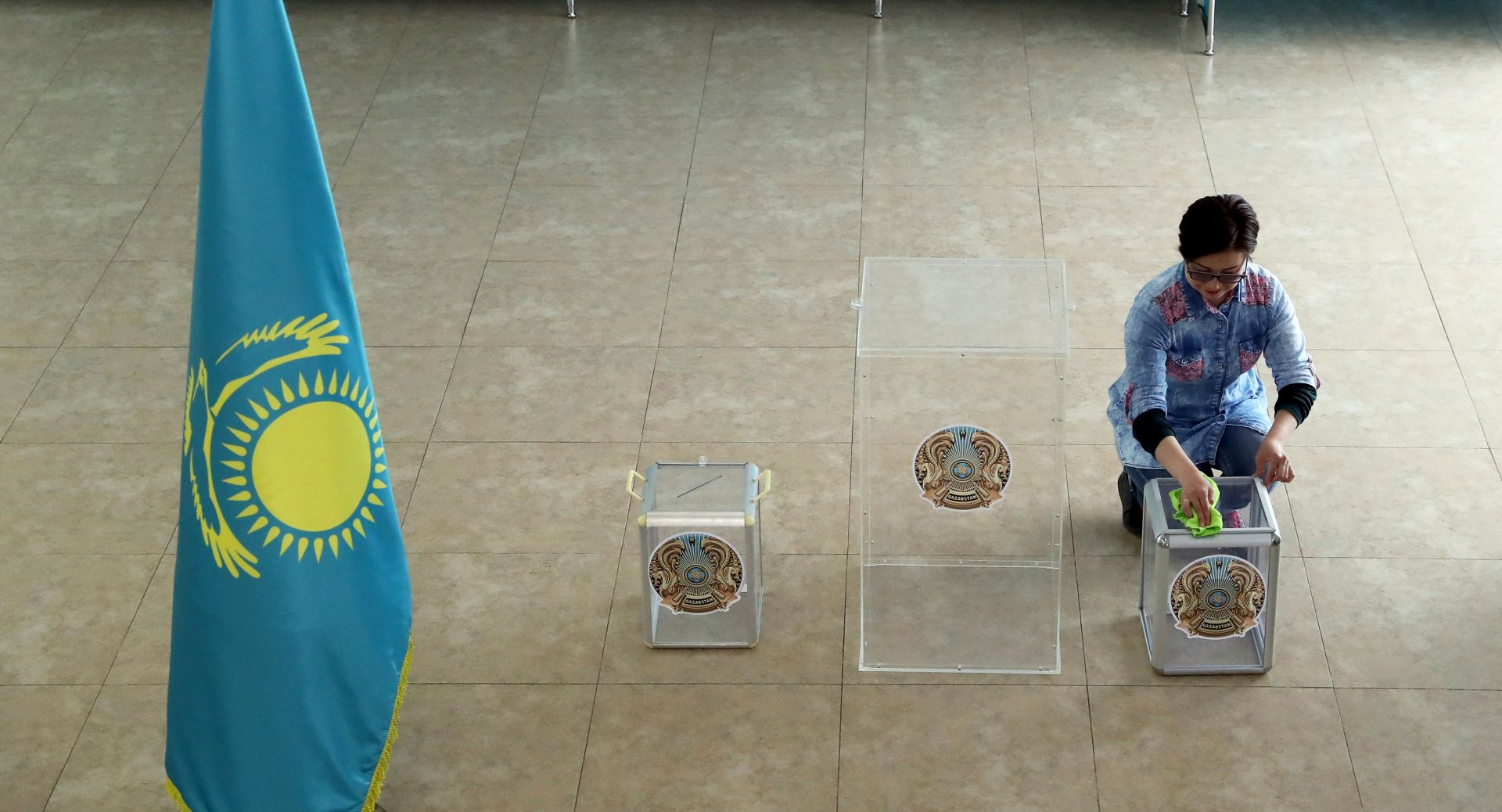 epa07634475 A member of the election commission prepares a polling station for the upcoming presidential elections in the capital city of Nur-Sultan (formerly known as Astana), Kazakhstan, 08 June 2019. President elections will be held in Nur-Sultan on 09 June 2019.  EPA/IGOR KOVALENKO