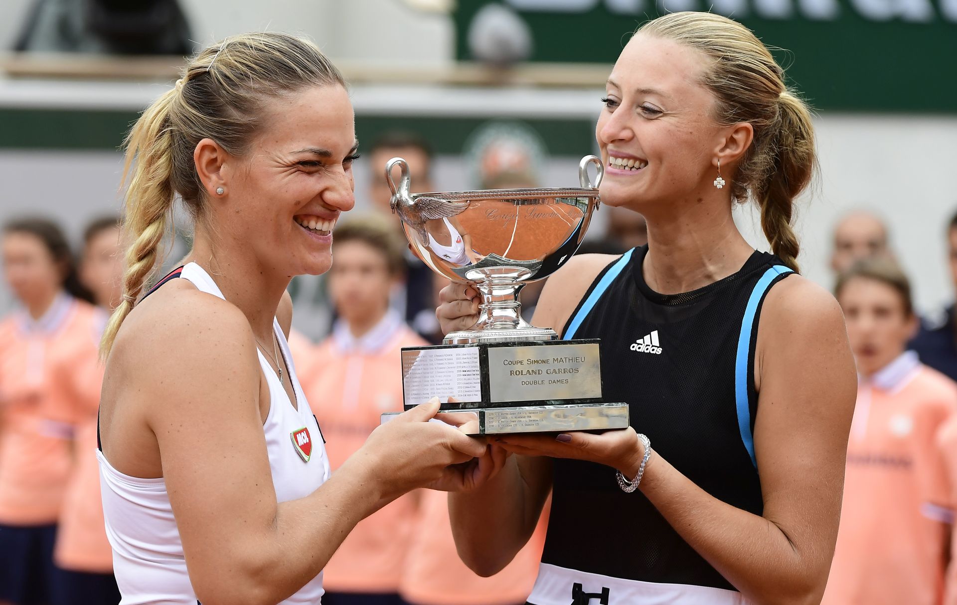 epa07636686 Timea Babos of Hungary (L) and Kristina Mladenovic of France pose with the trophy after winning the women’s doubles final match during the French Open tennis tournament at Roland Garros in Paris, France, 09 June 2019.  EPA/CAROLINE BLUMBERG