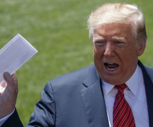 epa07641430 US President Donald J. Trump talks about a page from the USMCA as he responds to a question from the news media on the South Lawn of the White House in Washington, DC, USA, 11 June 2019. President Trump is traveling to Iowa to attend a renewable energy event and the Republican Party of Iowa annual dinner.  EPA/SHAWN THEW