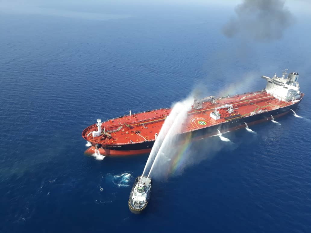 epa07646001 Iranian navy boat try to control a fire on the crude oil tanker Front Altair in the Gulf of Oman, 13 June 2019. According to the Norwegian Maritime Authority, three explosions wee reported on board the Front Altair in the Gulf of Oman after allegedly being attacked in the early morning of 13 June between the UAE and Iran.  EPA/STR