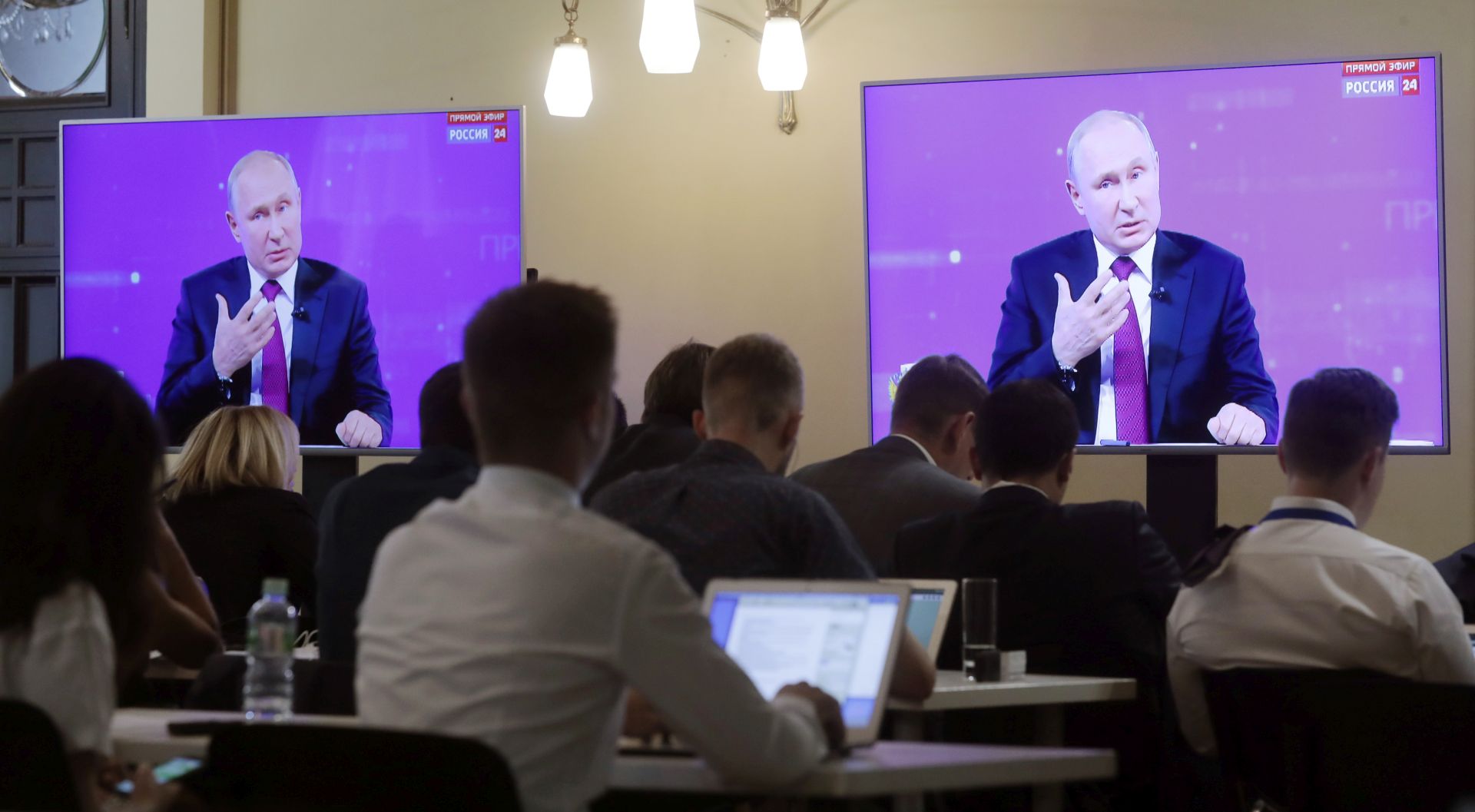 epa07659927 Russian journalists watch Russian President Vladimir Putin during his annual Question and Answer live-broadcast nationwide television and radio session 'Direct Line with Vladimir Putin' at the Gostiny Dvor studio in Moscow, Russia, 20 June 2019. During the broadcast President Vladimir Putin directly answers questions from Russia's citizens.  EPA/SERGEI CHIRIKOV