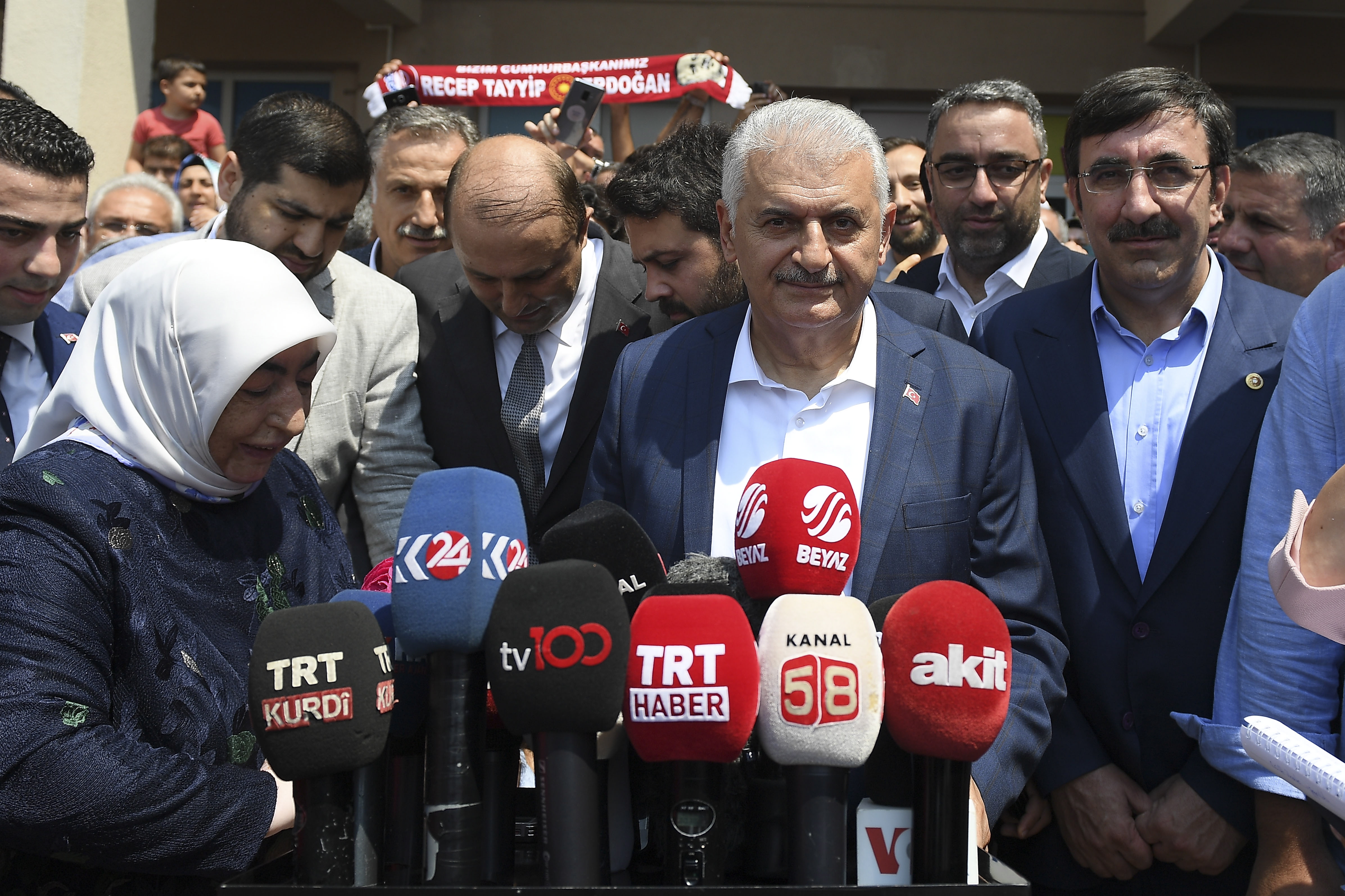 epa07667752 Turkish ruling party Justice and Development Party (AKP) candidate for Istanbul mayor, Binali Yildirim (C), next to his wife Semiha Yildirim (L), speaks to the media after casting his vote in the Istanbul mayoral elections re-run, in Istanbul, Turkey, 23 June 2019. Some 10.5 million people will vote on the day in a re-run of the mayoral election. The Turkish Electoral Commission ordered a repeat of the mayoral election in Istanbul for 23 June 2019, after Turkish President Erdogan's AK Party had alleged there was 'corruption' behind his party losing in the 31 March 2019 polls.  EPA/AKIN CELIKTAS