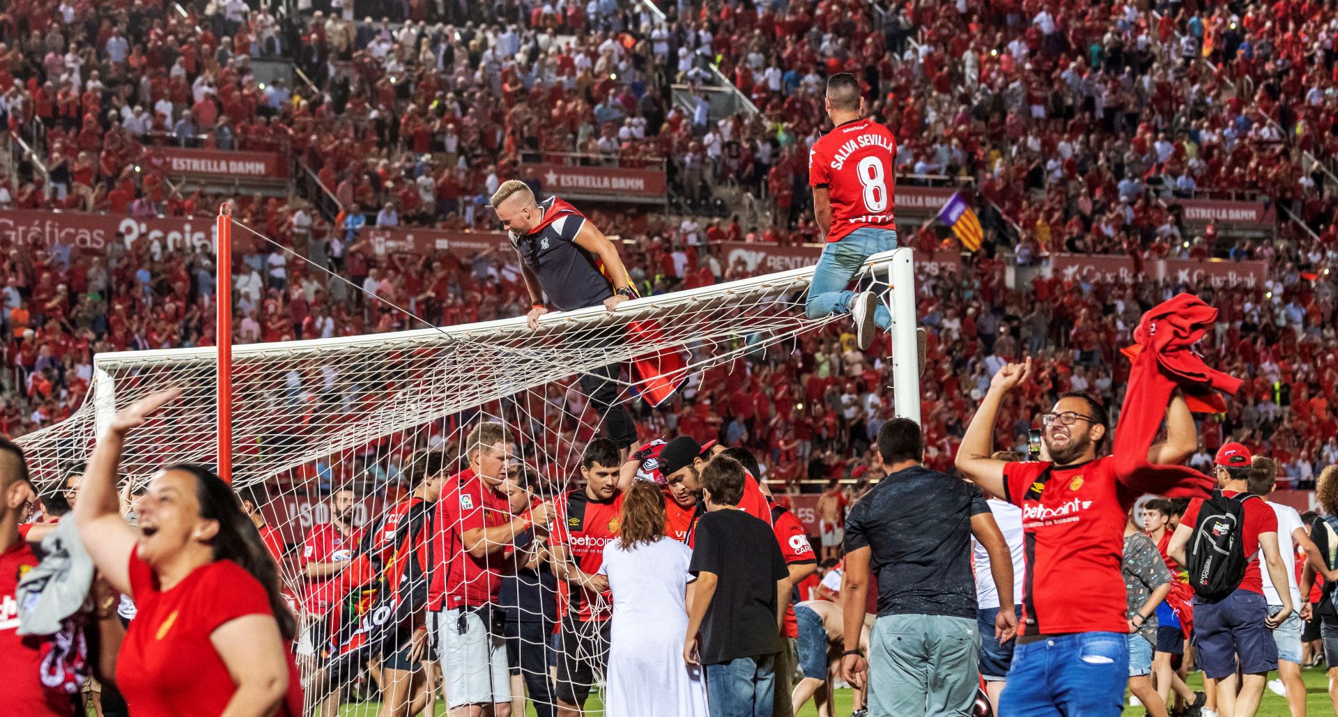 epa07669837 Mallorca FC fans celebrate the promotion of their team to first division after their victory against Deportivo de la Coruna in Palma de Mallorca, Spain, 23 June 2019 (issued 24 June 2019). Mallorca FC managed the promotion to the first division league after beating Deportivo de la.  EPA/CATI CLADERA