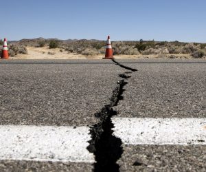epaselect epa07695842 A cone indicates the localization of a crack in the road after an earthquake near Ridgecrest shook Southern California, USA, 04 July 2019. Earlier on the same day, a magnitude 6.4 earthquake shook Southern California. It's epicenter is located 150 miles north of Los Angeles near the cities of Ridgecrest and Trona.  EPA/ETIENNE LAURENT