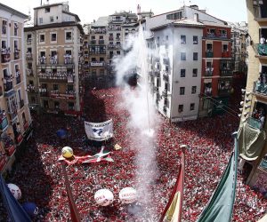 epa07698560 People attend the traditional firing of the 'chupinazo' that marks the beginning of the Festival of San Fermin 2019 at the City Hall Square in Pamplona, Spain, 06 July 2019. The firing of a rocket, the chupinazo, from the City Hall's balcony at midday signals the beginning of event. The festival, locally known as Sanfermines, is held annually from 06 to 14 July in commemoration of the city's patron saint. Hundreds of thousands of visitors from all over the world attend the fiesta. Many of them physically participate in the highlight event - the running of the bulls, or encierro - where they attempt to outrun the bulls along a route through the narrow streets of the old city.  EPA/JESUS DIGES / POOL
