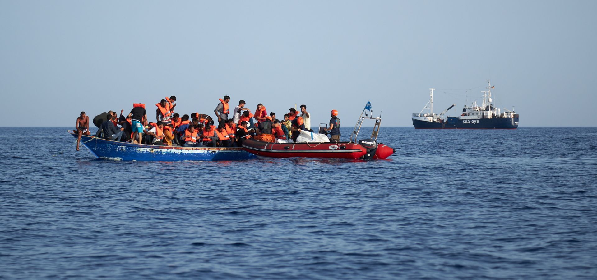 epa07704799 A handout photo made available by German civil sea rescue organisation sea-eye shows a boat carrying migrants (L) and a rescue boat of sea-eye, in the Mediterranean Sea, 08 July 2019 (issued 09 July 2019). According to sea-eye, 44 people were rescued from a woodden boat floating in the Mediterranean between Malta and Lampedusa. The migrants were taken onboard the Alan Kurdi rescue vessel operated by sea-eye and are expected to be transferred to land by the Maltese Navy.  EPA/FABIAN HEINZ / SEA-EYE HANDOUT  HANDOUT EDITORIAL USE ONLY/NO SALES